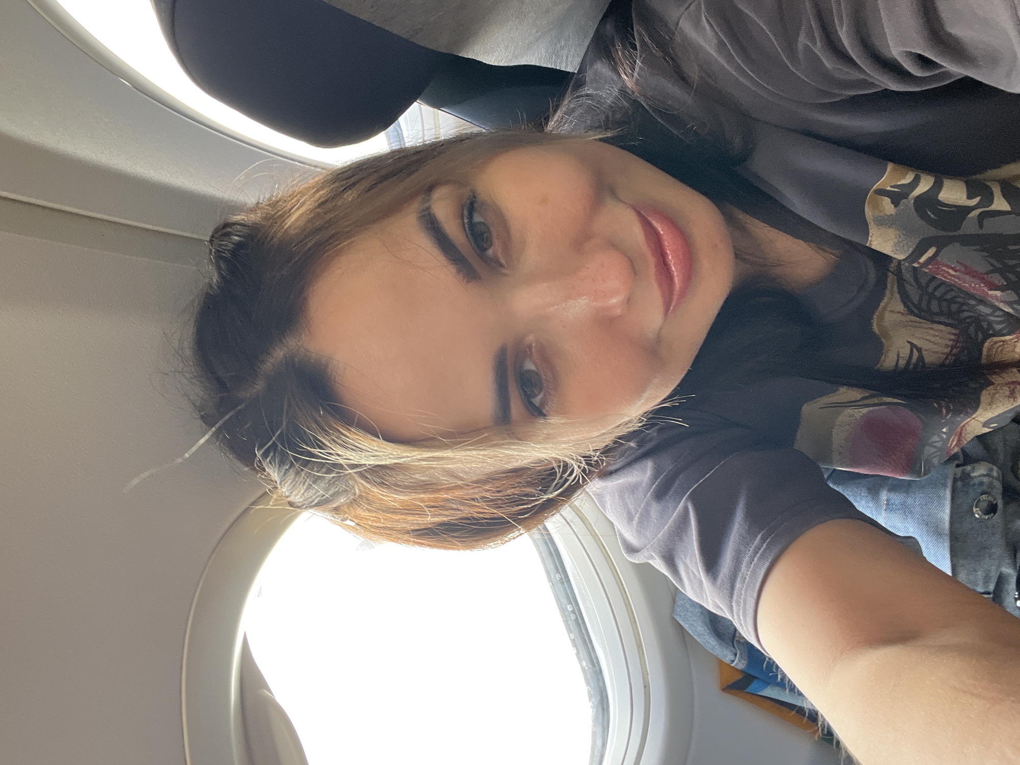 Woman Documents Flight Experience with Selfies and Aerial Views