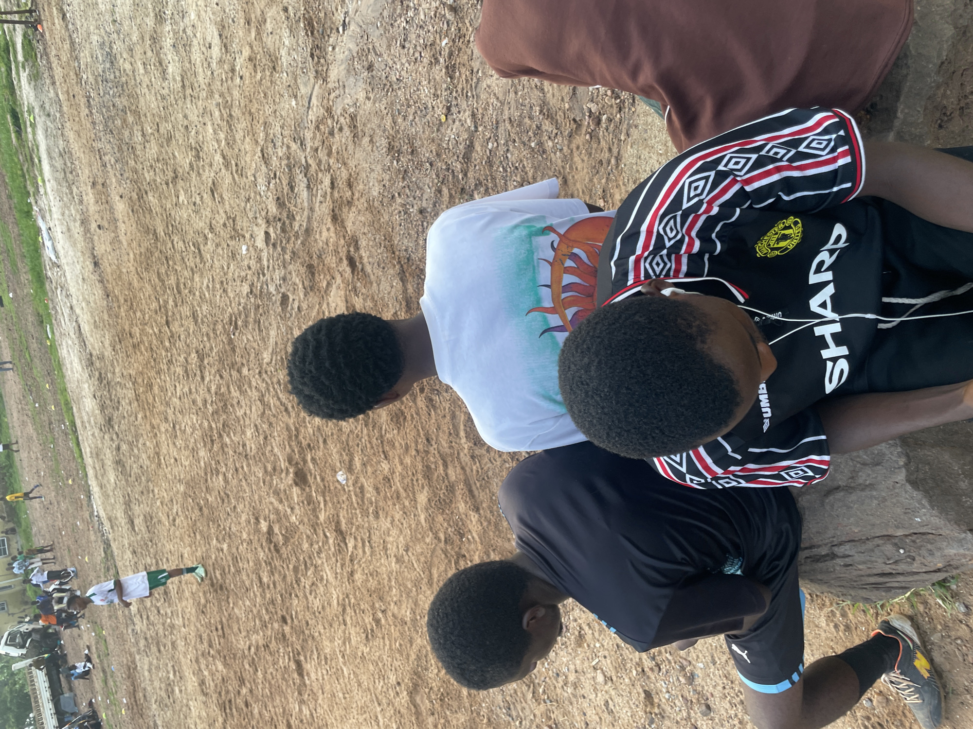 Pickup football on a dirt field in Lokoja, Nigeria