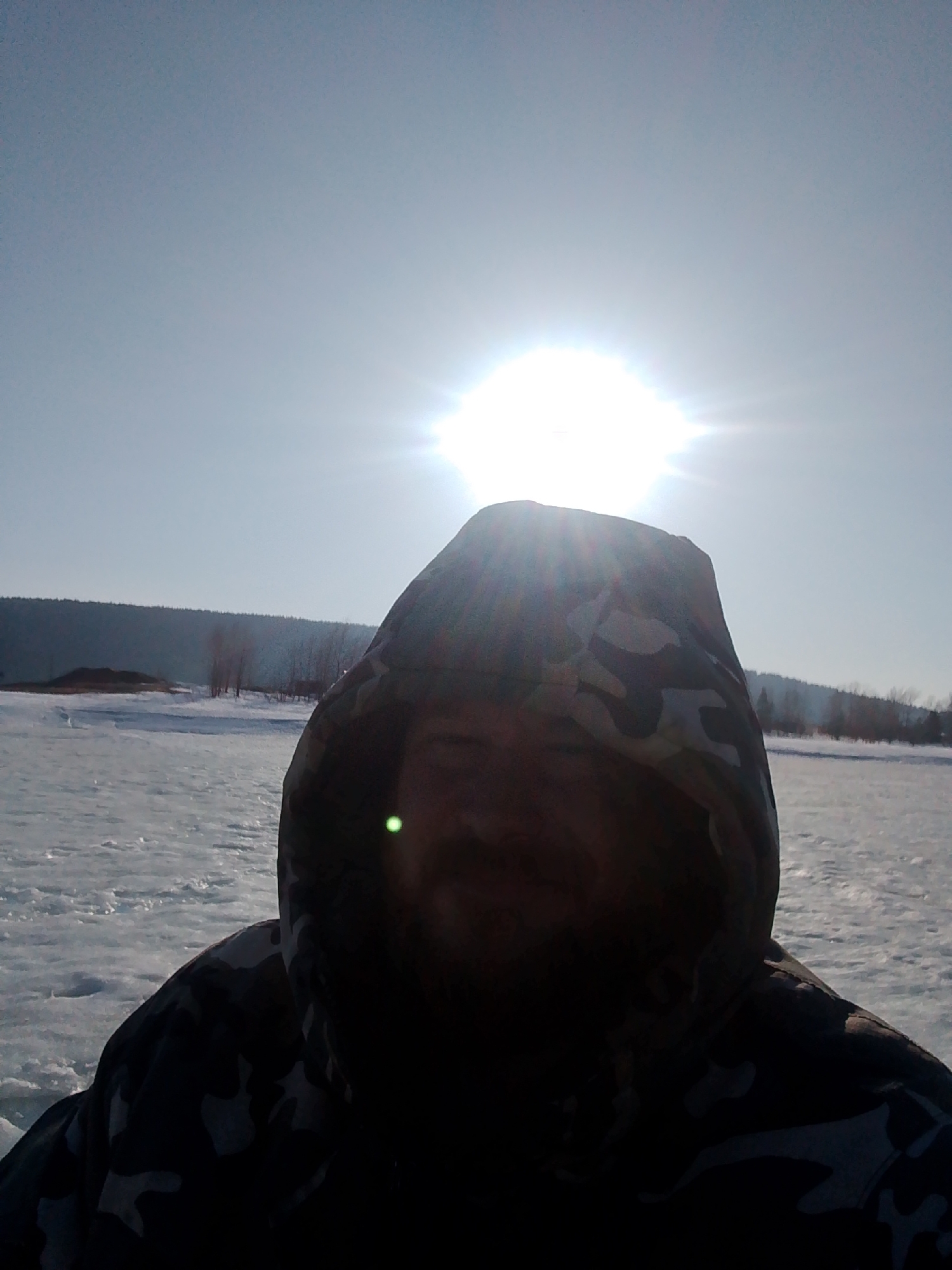 Ice fishing scene documented on frozen lake near Noviy, Russia