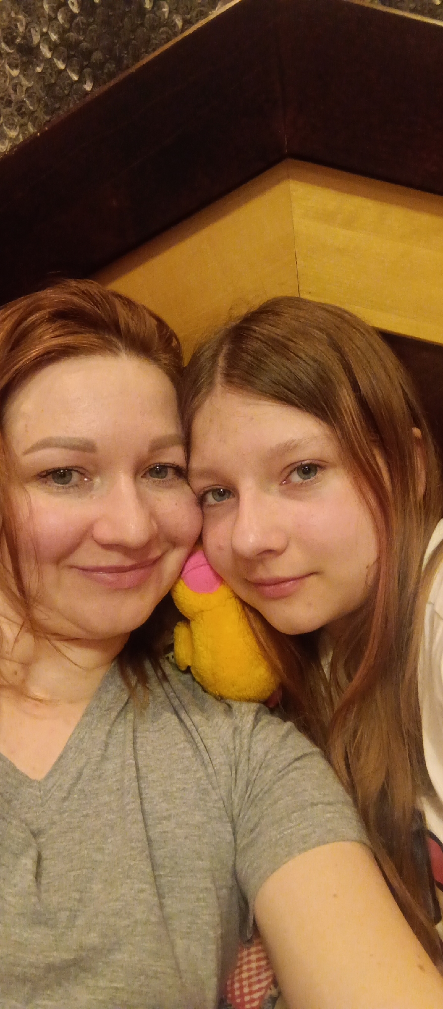 Mother and daughter share intimate portrait moment indoors