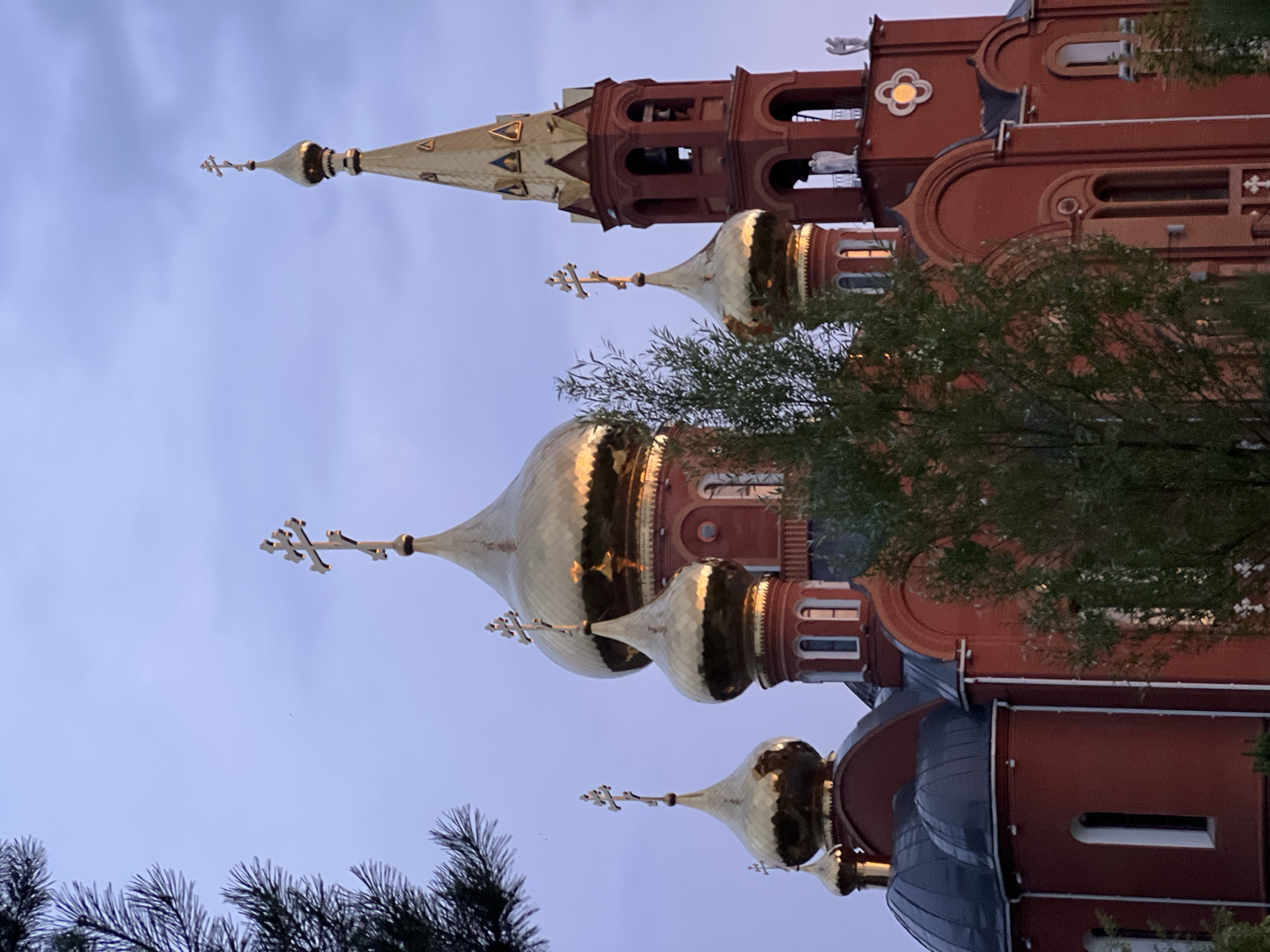 Golden-domed Orthodox churches photographed at dusk in Chaikovsky, Russia