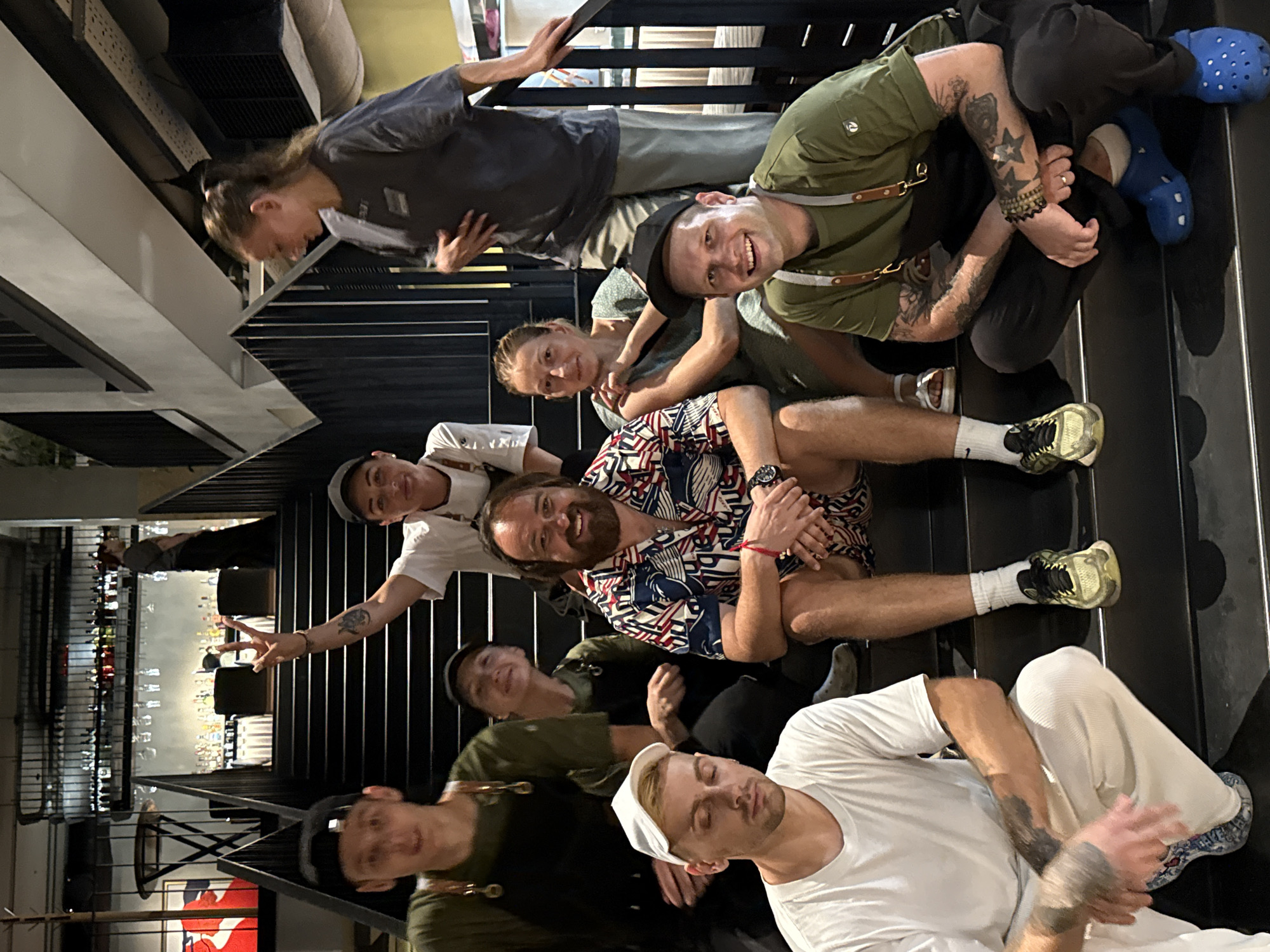 Staff gather on the staircase of a dark, moody bar