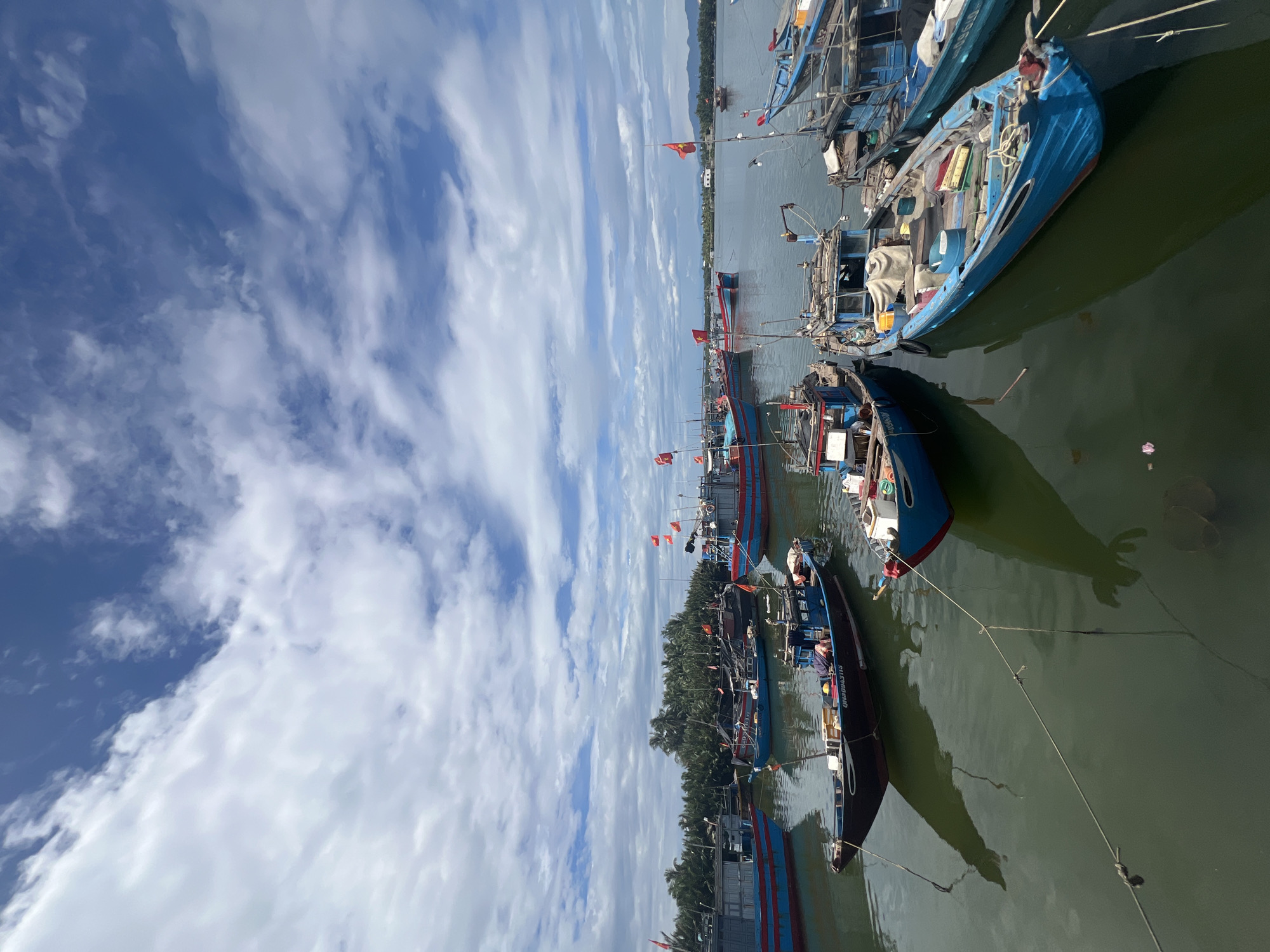 Fishing boats and aquaculture farms along the Hoi An waterfront