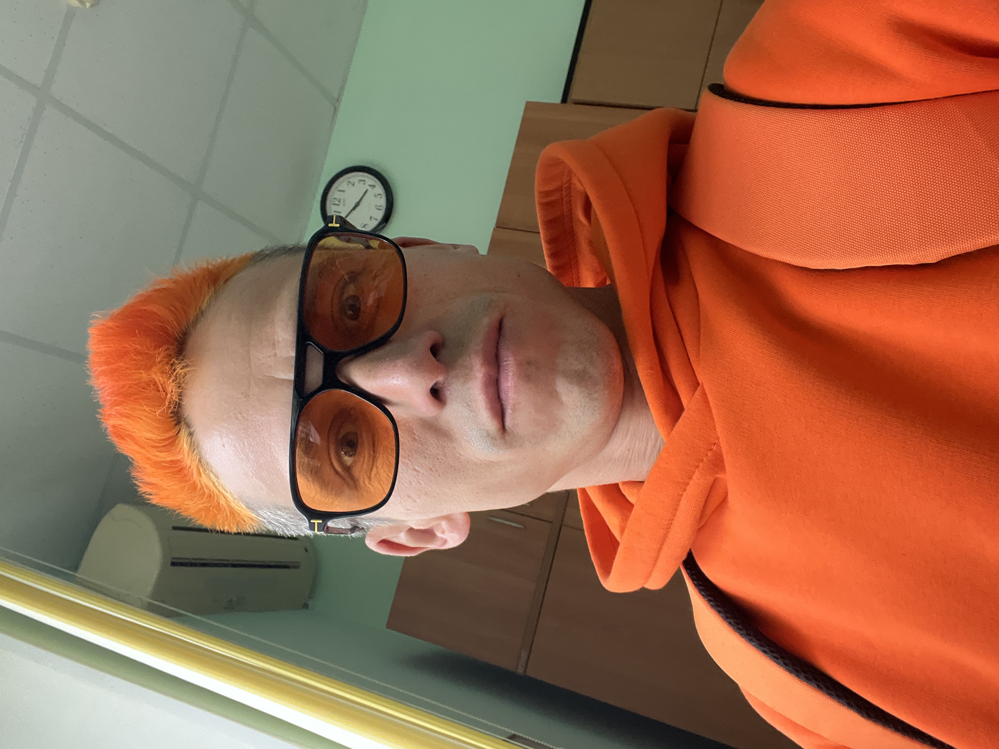 Orange-haired man takes selfies in Chaikovsky, Russia apartment