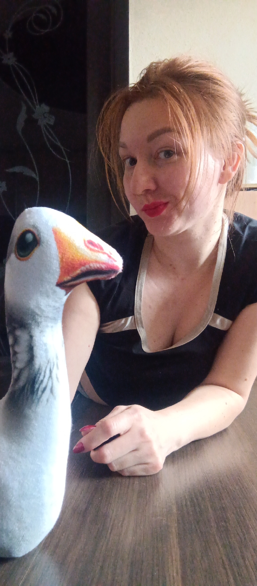 Woman photographed indoors with plush toy and craft materials