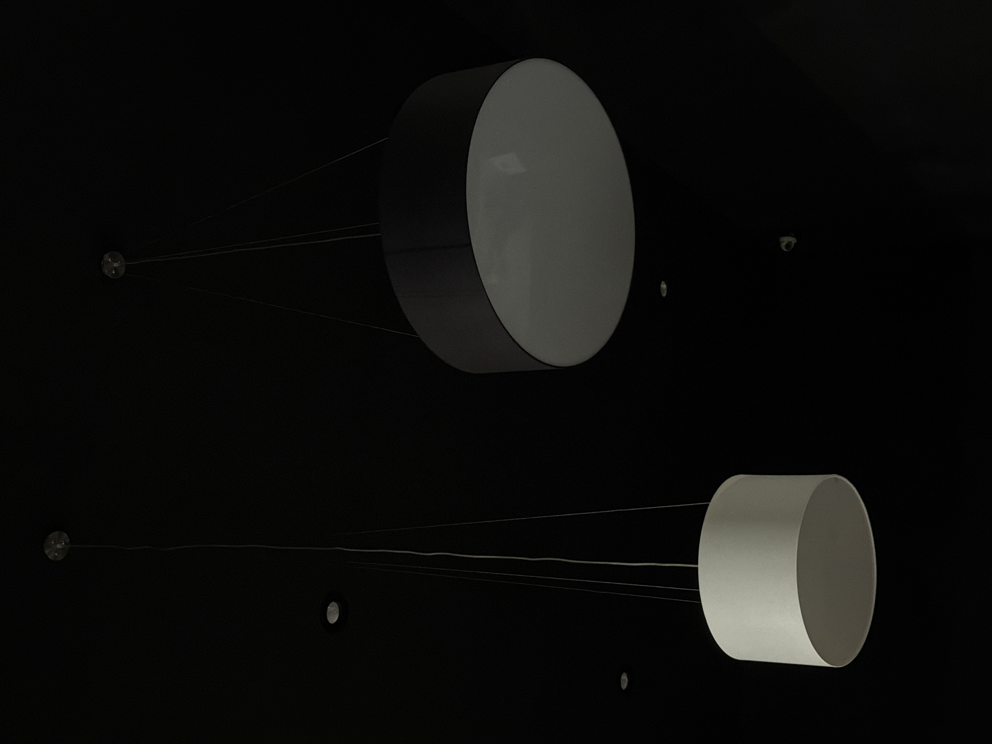 Cylindrical light fixtures observed in dark Izhevsk interior