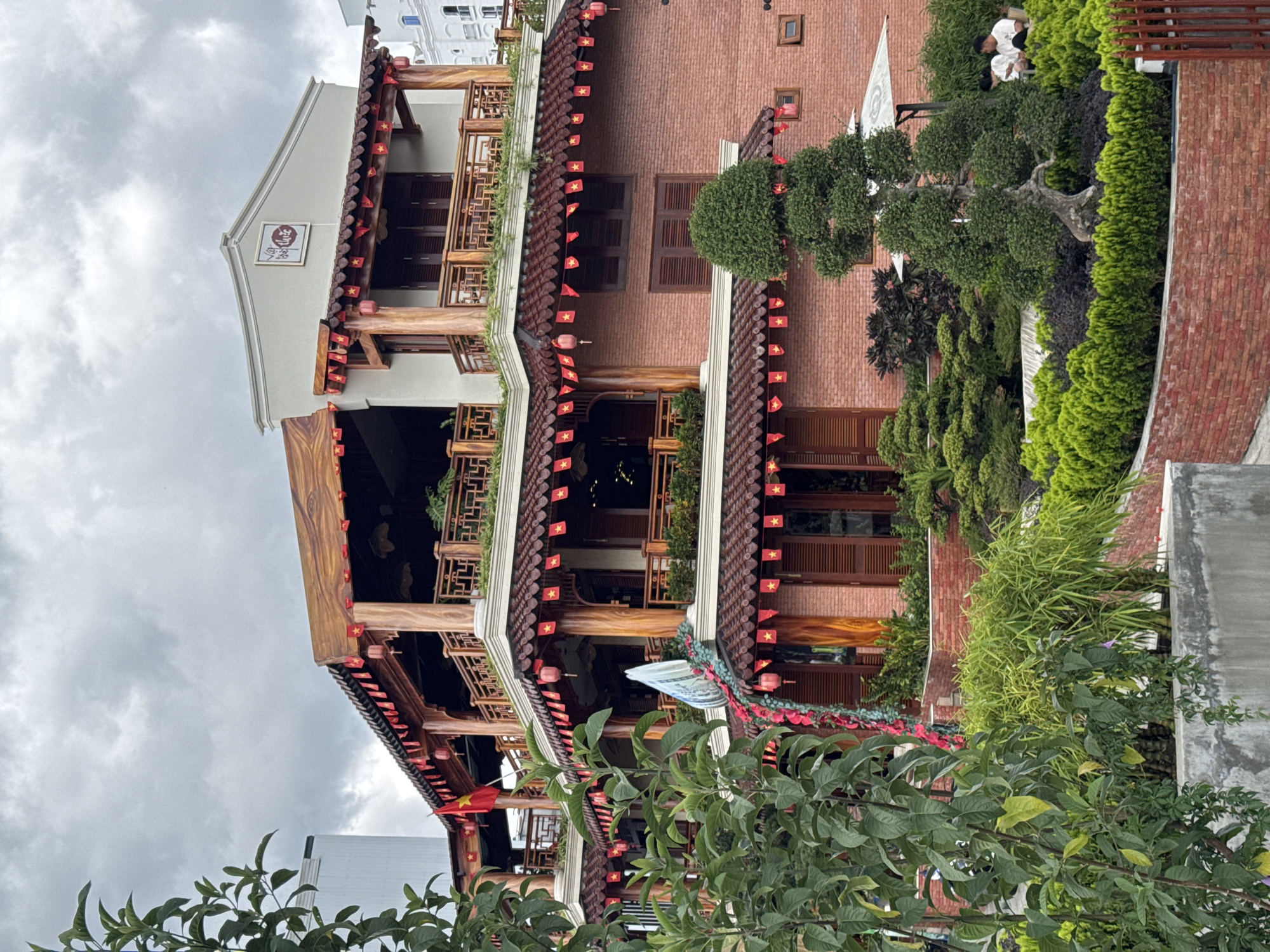 Traditional Vietnamese building with flags observed in Da Lat