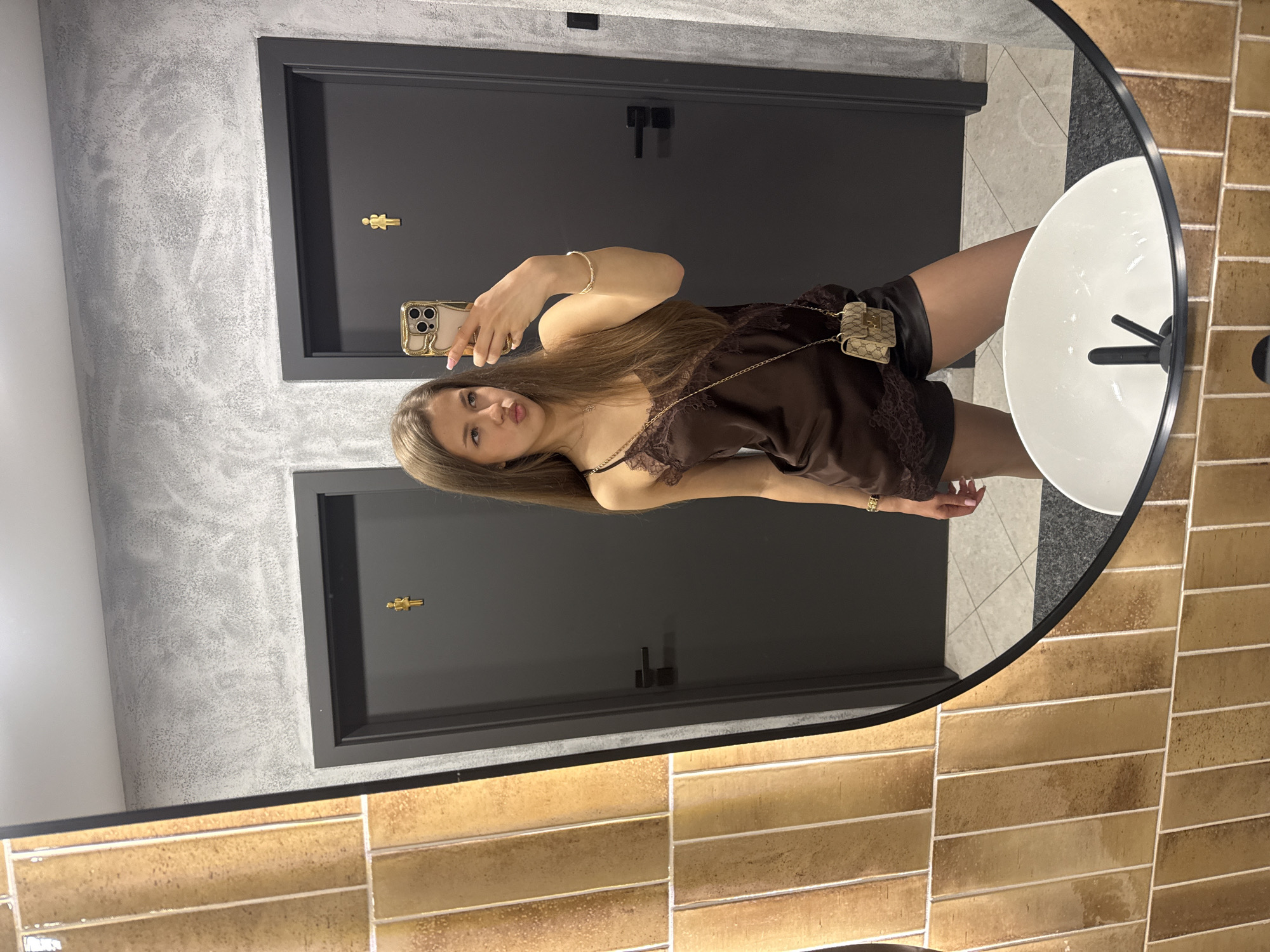 Woman takes mirror selfie in Ruse restroom