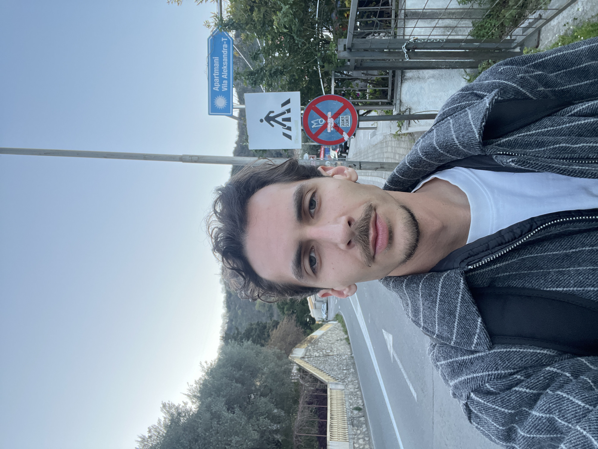 Tourist captures selfie during dawn hours in Budva, Montenegro
