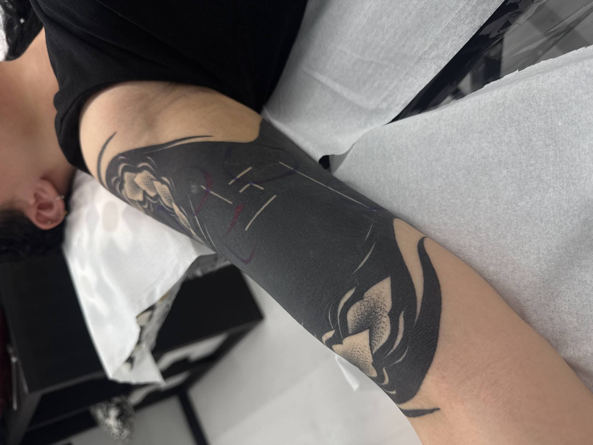 Person gets elaborate floral tattoo sleeve in Sofia studio