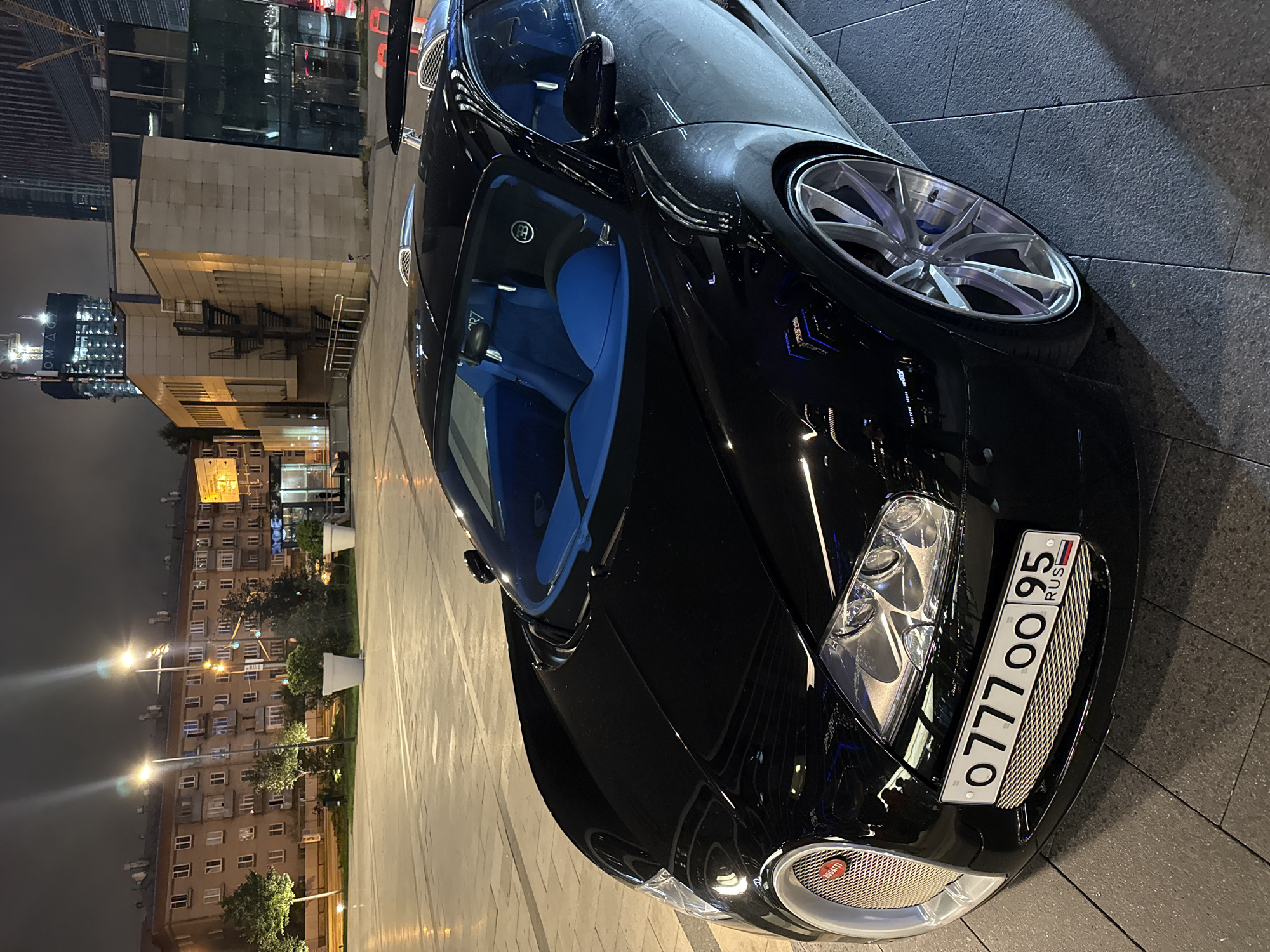 Black Bugatti Veyron Super Sport parked outside Khimki restaurant at night