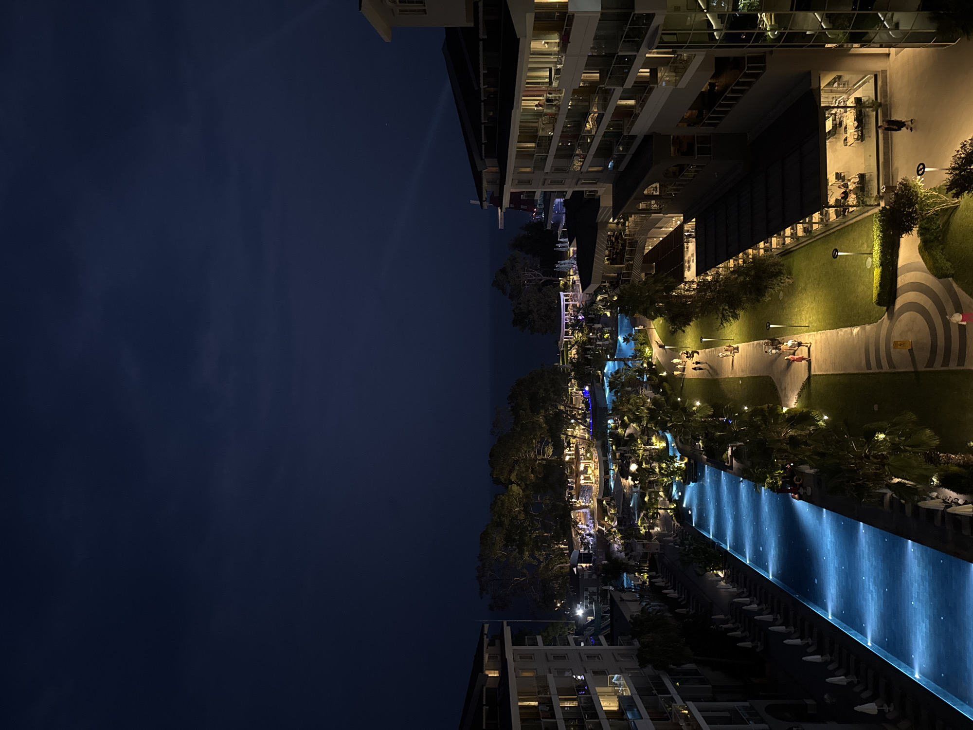 Illuminated resort pool glows at night in Kemer, Turkey