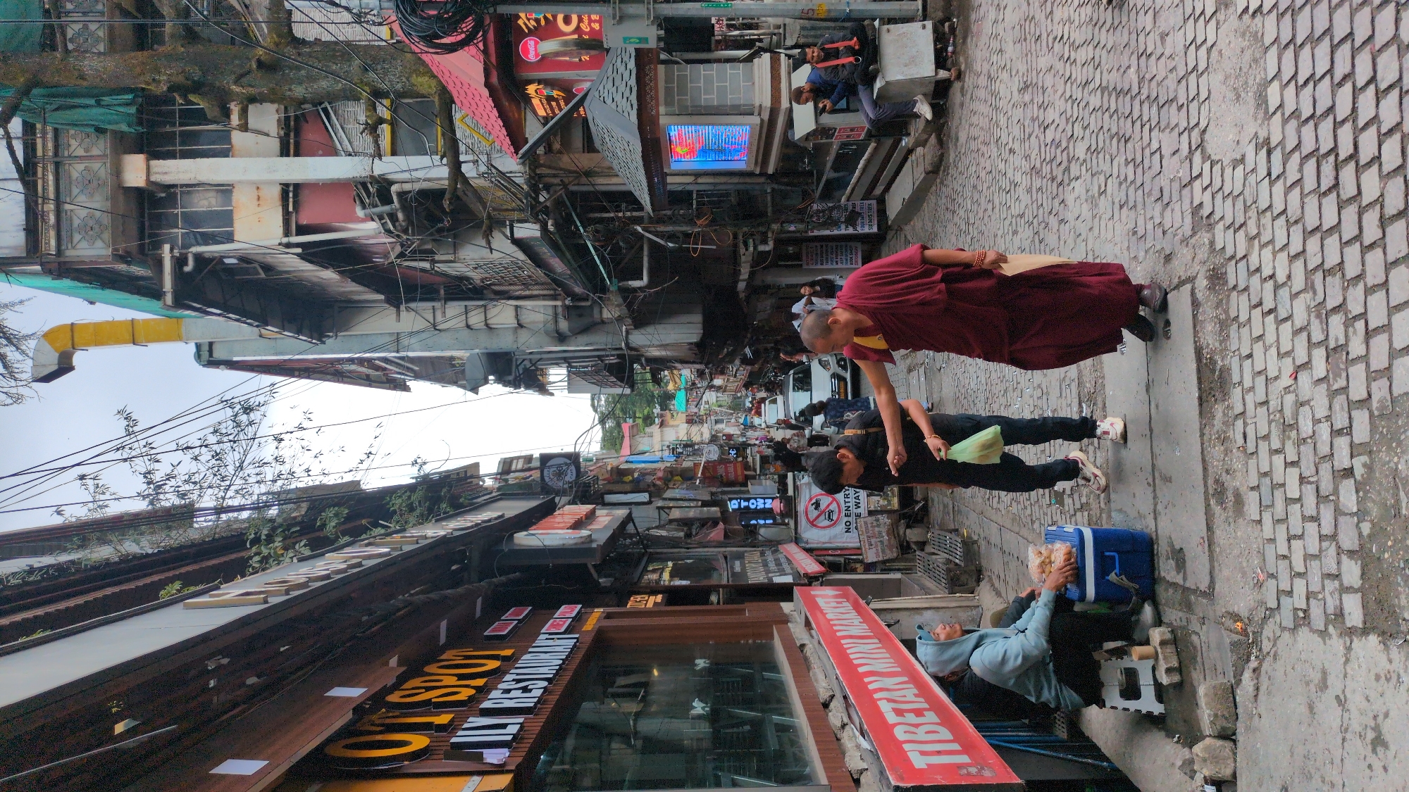 Morning street activity captured in Bhagsu, India alleyway
