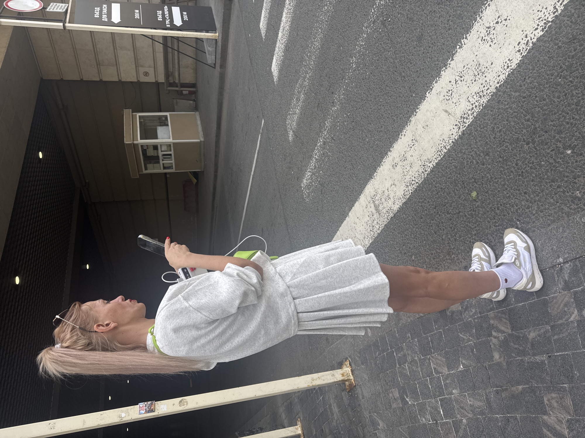 Woman takes selfies during morning walk through Saint Petersburg