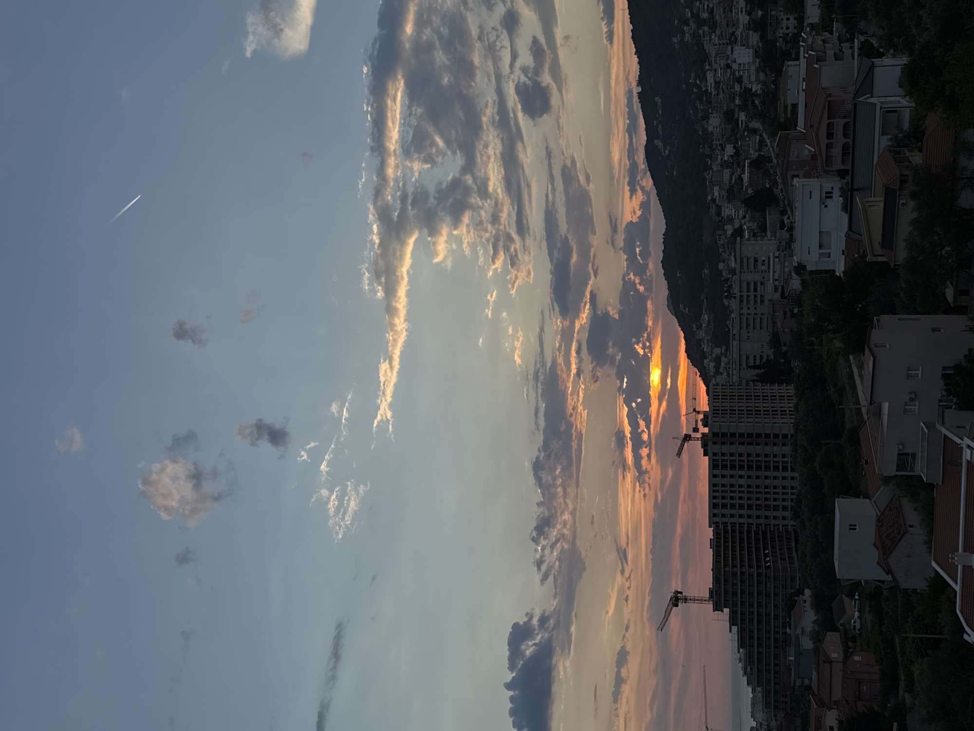Sunset over Šušanj's coastline, mountains, and modern architecture