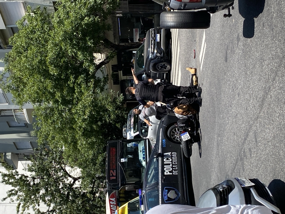 Motorcycle accident attended by police in busy Buenos Aires street