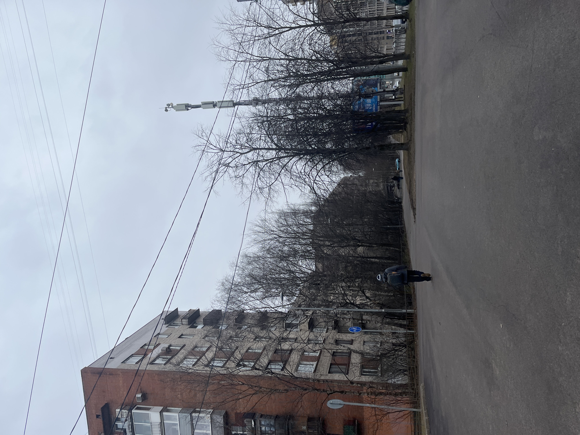 Pedestrian documents overcast street scene in Saint Petersburg