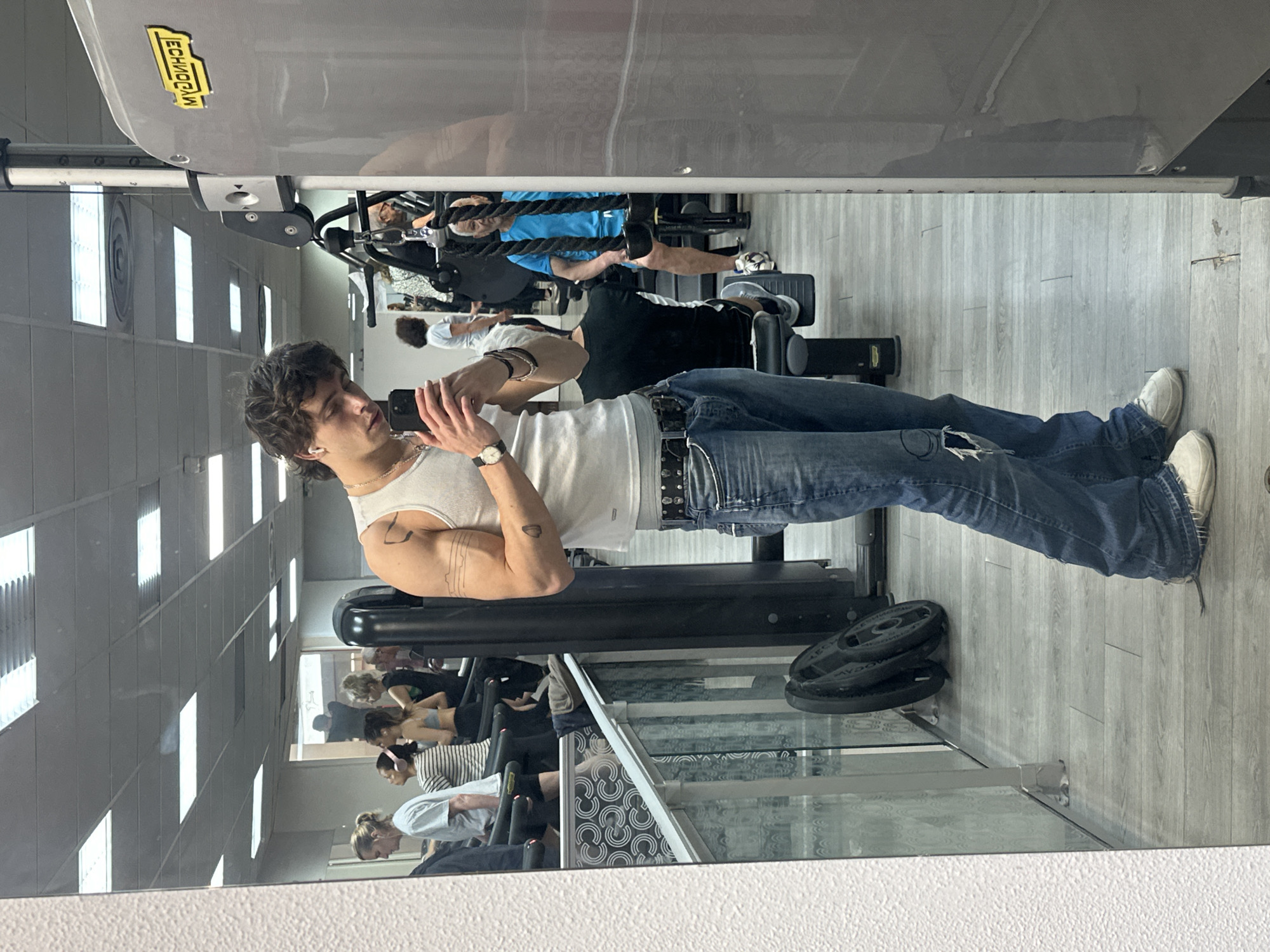 Person takes mirror selfie at Paris gym