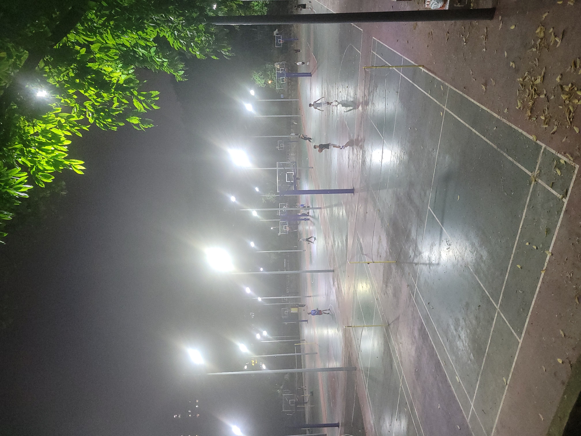 Nighttime street life and basketball activity in Shapingba District