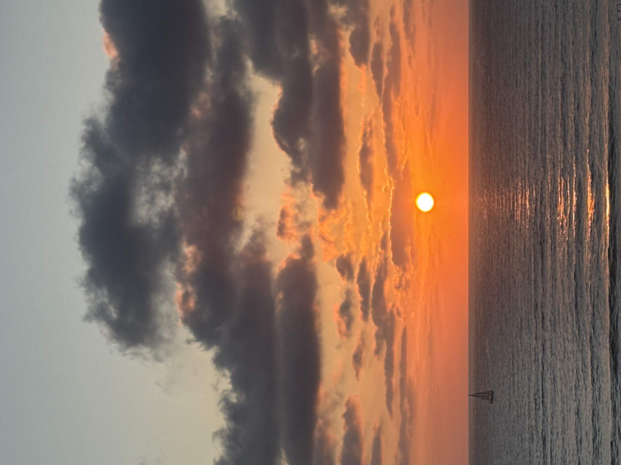 Sailboat on calm Mediterranean waters at Herzliya sunset