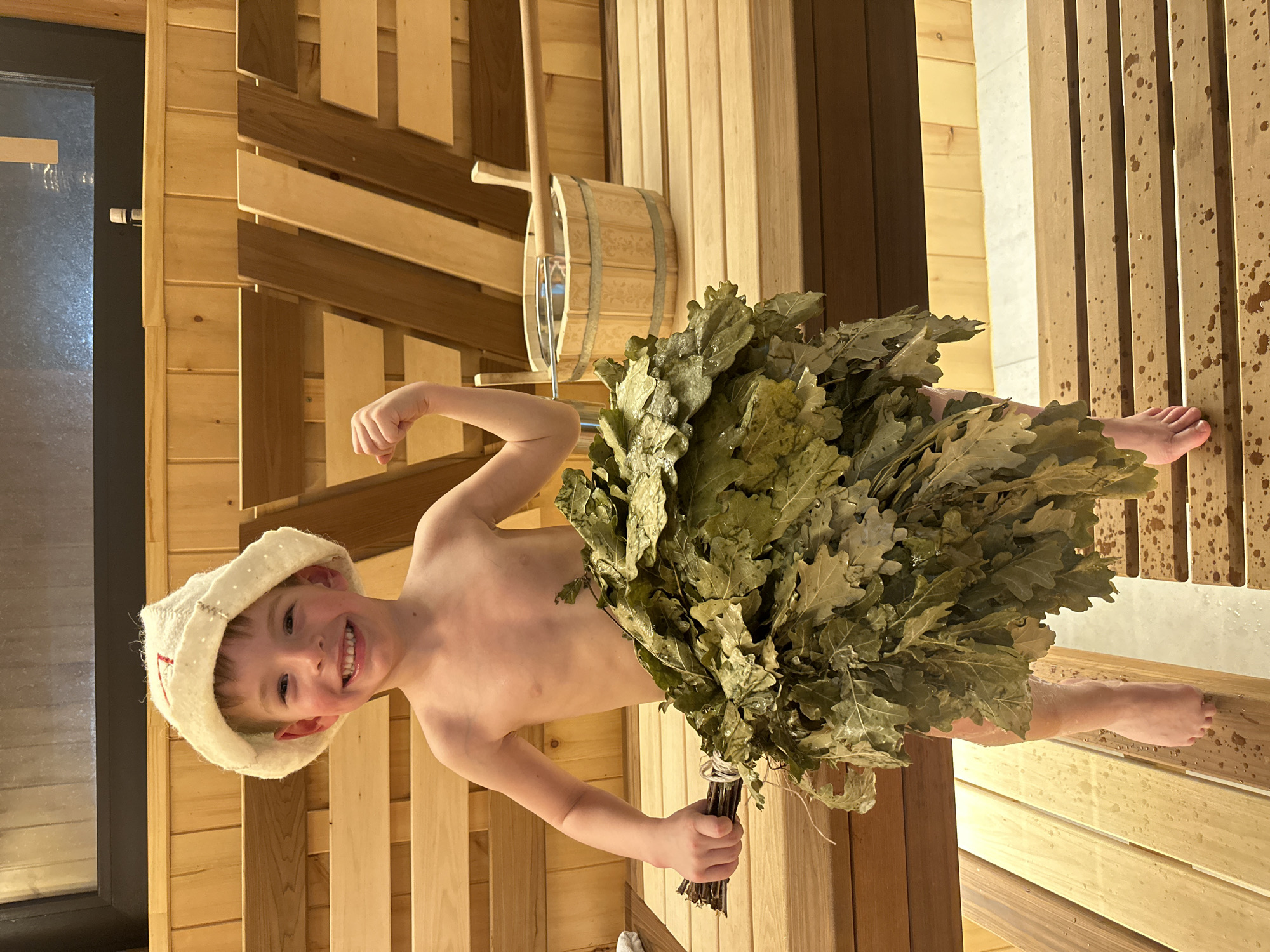 Boy enjoys traditional Russian banya sauna experience
