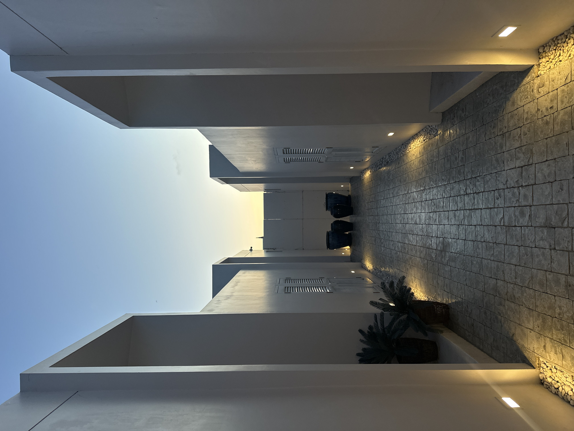 Lit concrete pathway leads to blue ceramic vases, Choeng Thale