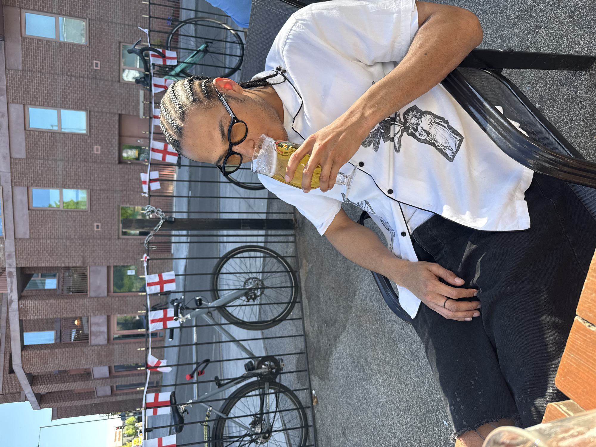 Person enjoys yellow drink outdoors in London