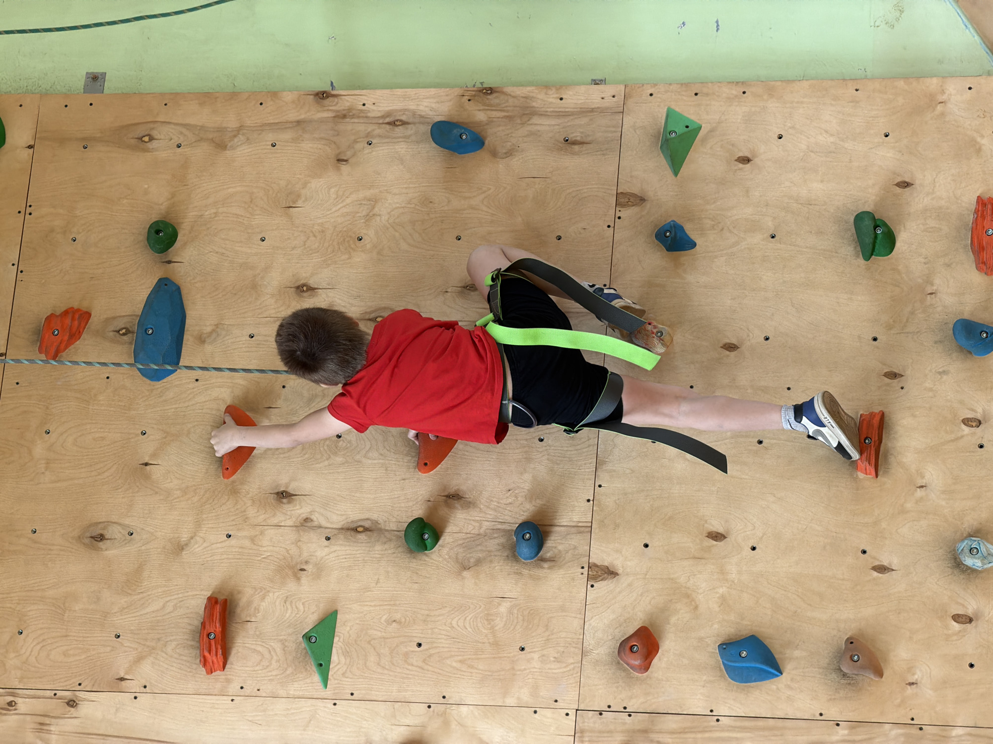 Boy rock climbs at indoor facility in Izhevsk