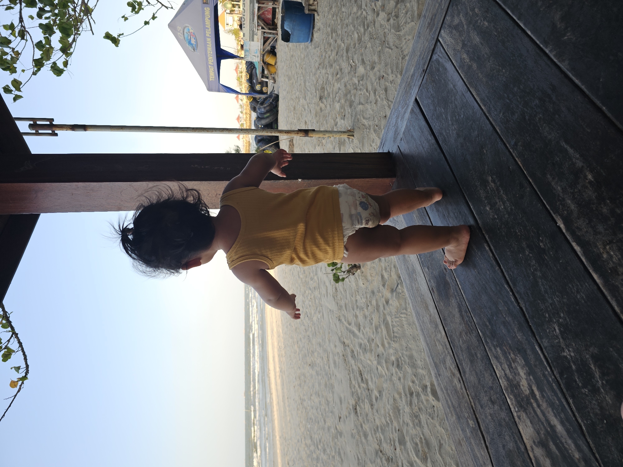 Toddler plays on Dalegan Beach while the shoreline stays calm