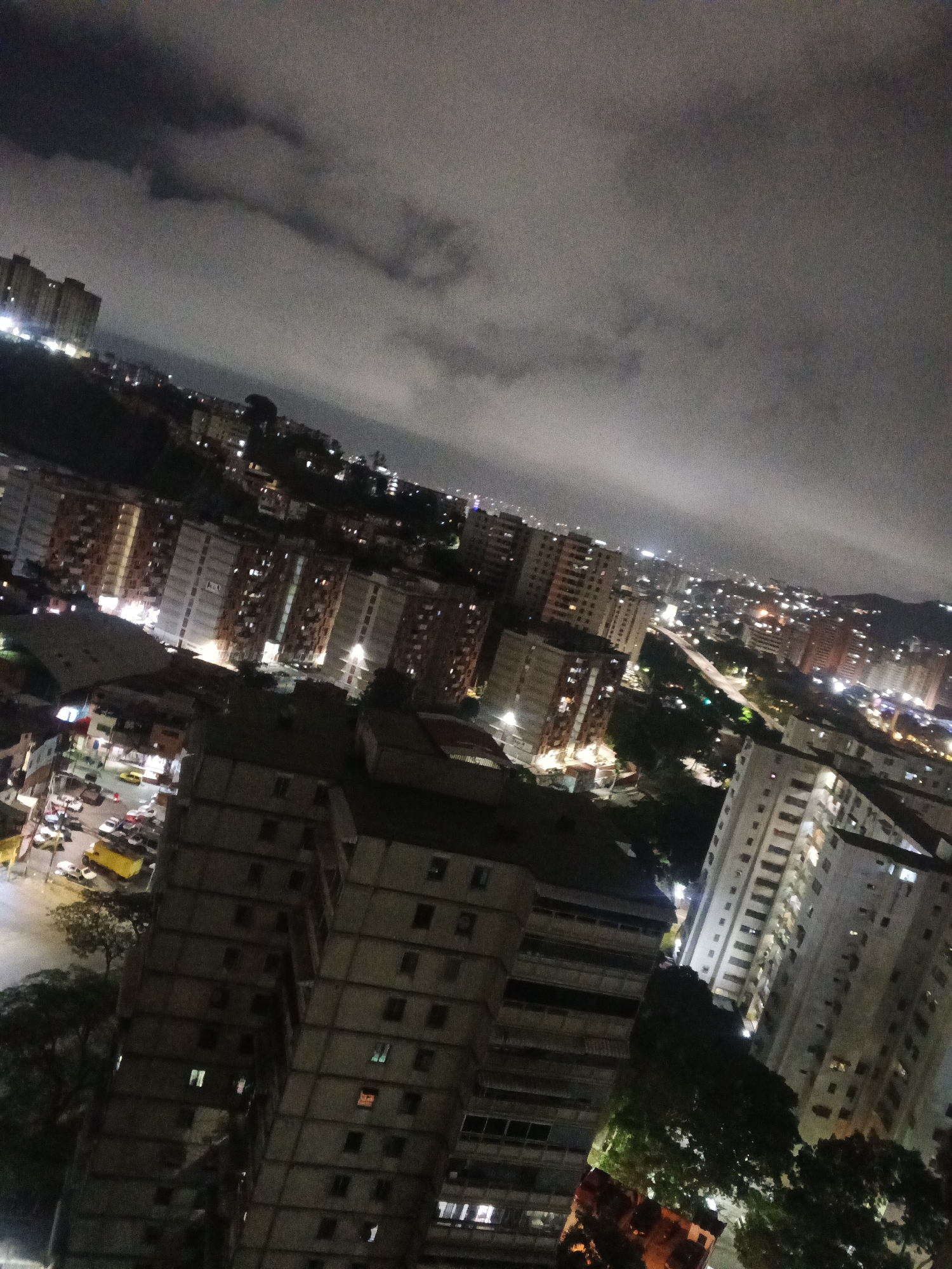 Nighttime Caracas captured from rooftops to living rooms