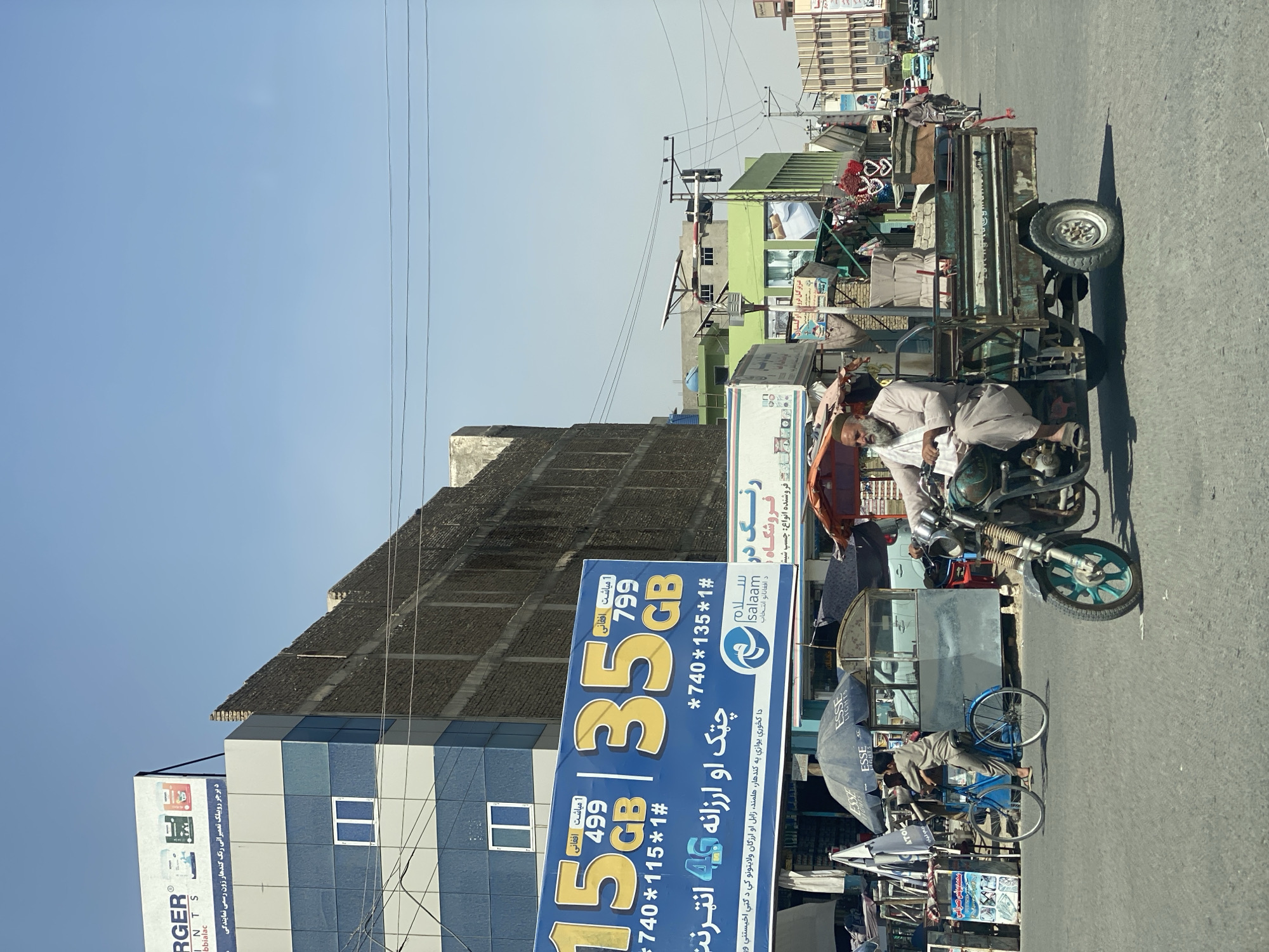 Three-wheeled transport on a busy Kandahar street