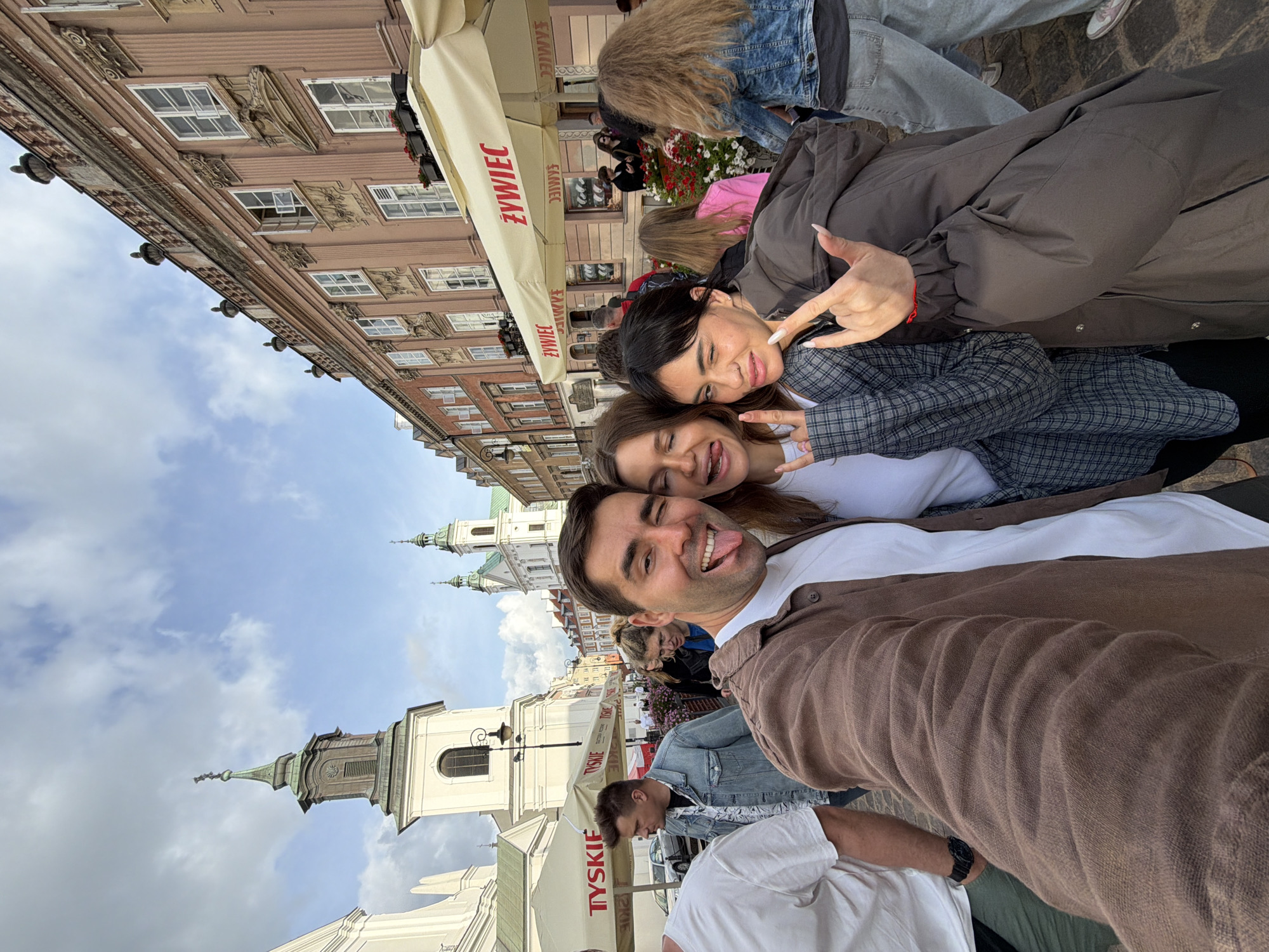 Playful group selfie on a Warsaw street