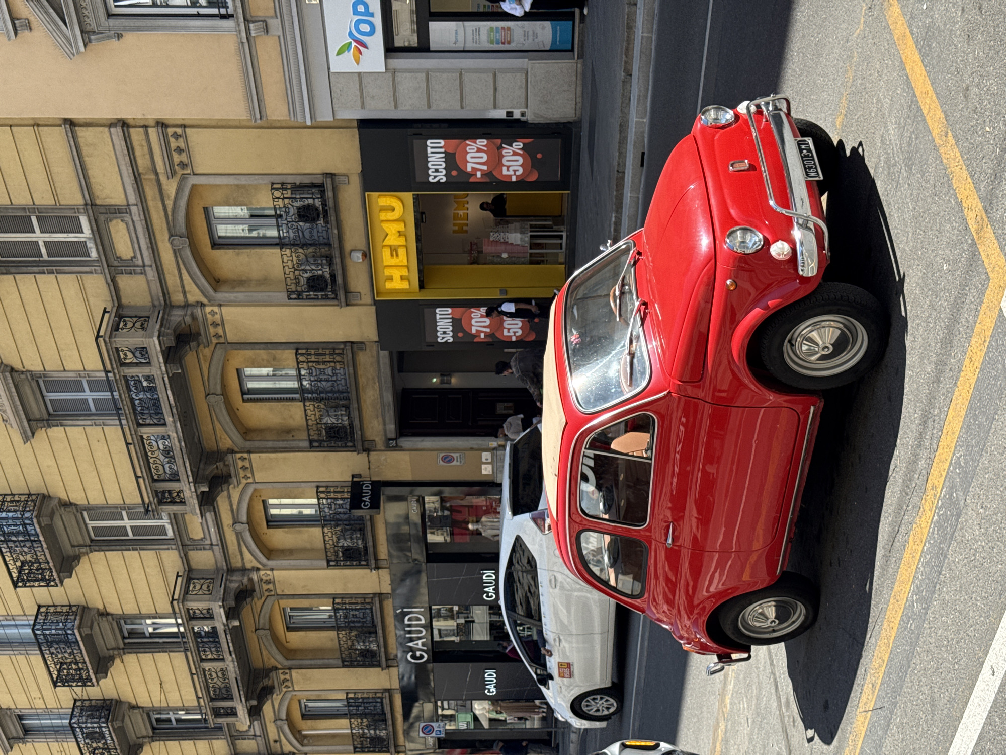 Red vintage Fiat 500 spotted parked on Milan street