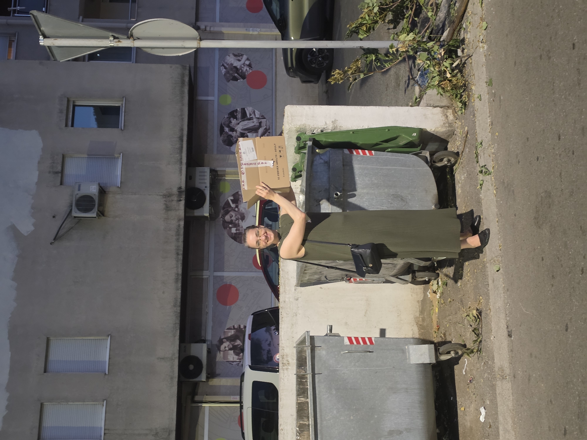 Disposing of cardboard box at street trash receptacles in Podgorica