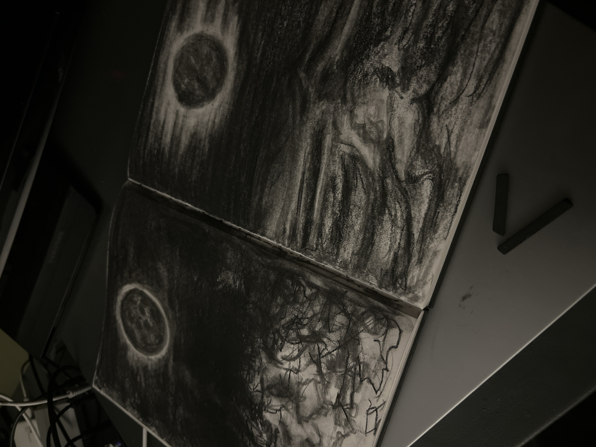 Charcoal celestial artwork documented in Cape Coral sketchbook