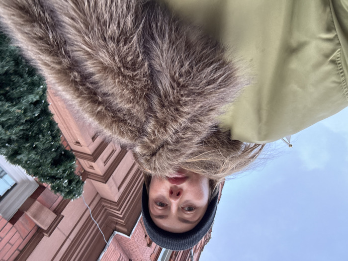 Woman photographed on overcast London street wearing winter clothing