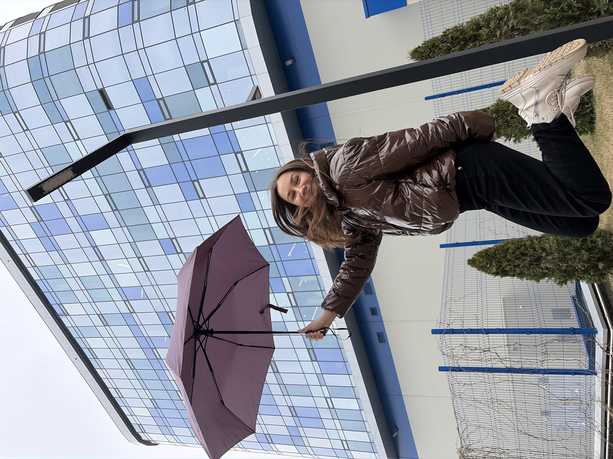 Woman with purple umbrella spotted near building in Izhevsk