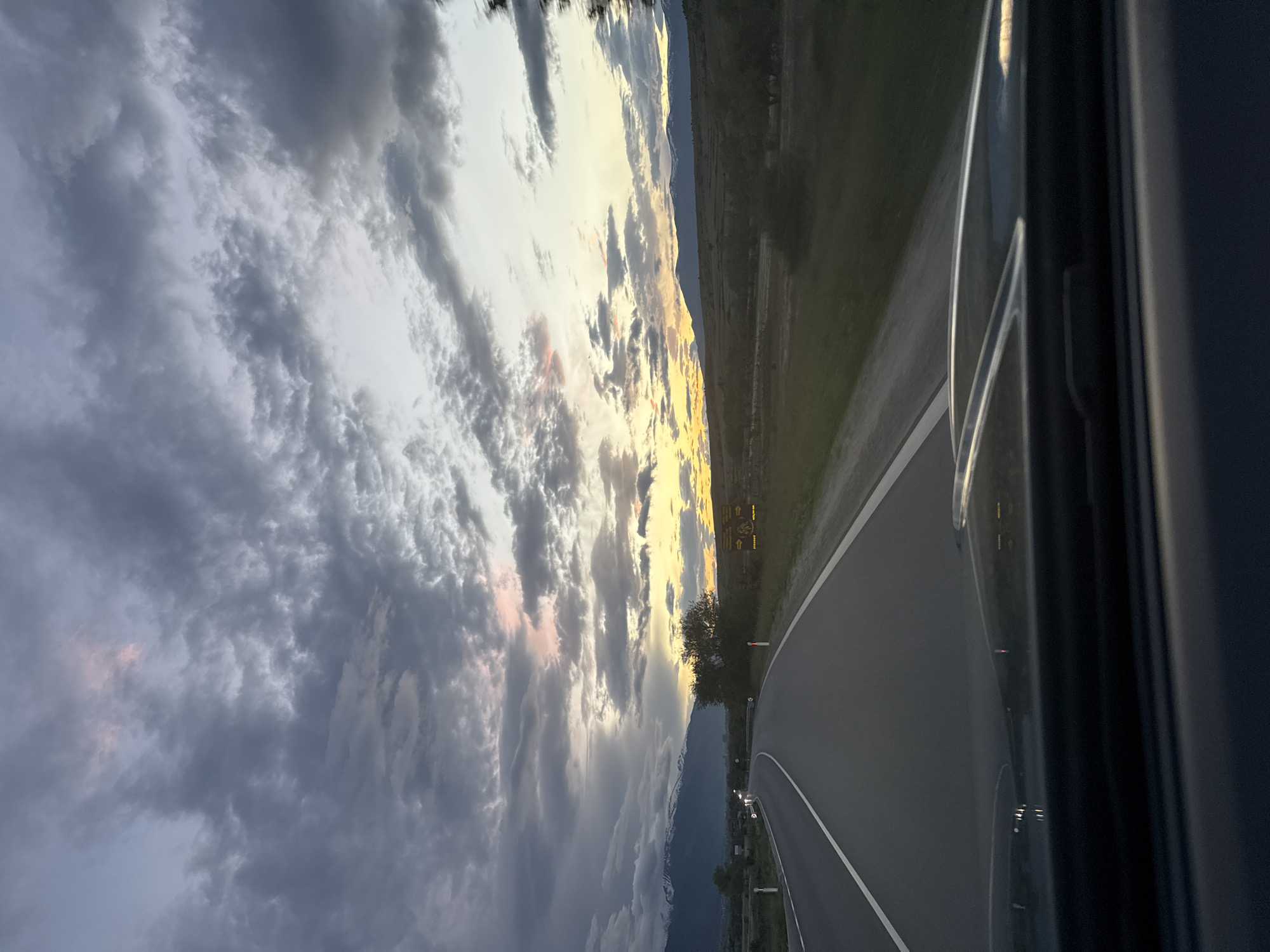 Driver travels mountain roads at dusk in Volkswagen