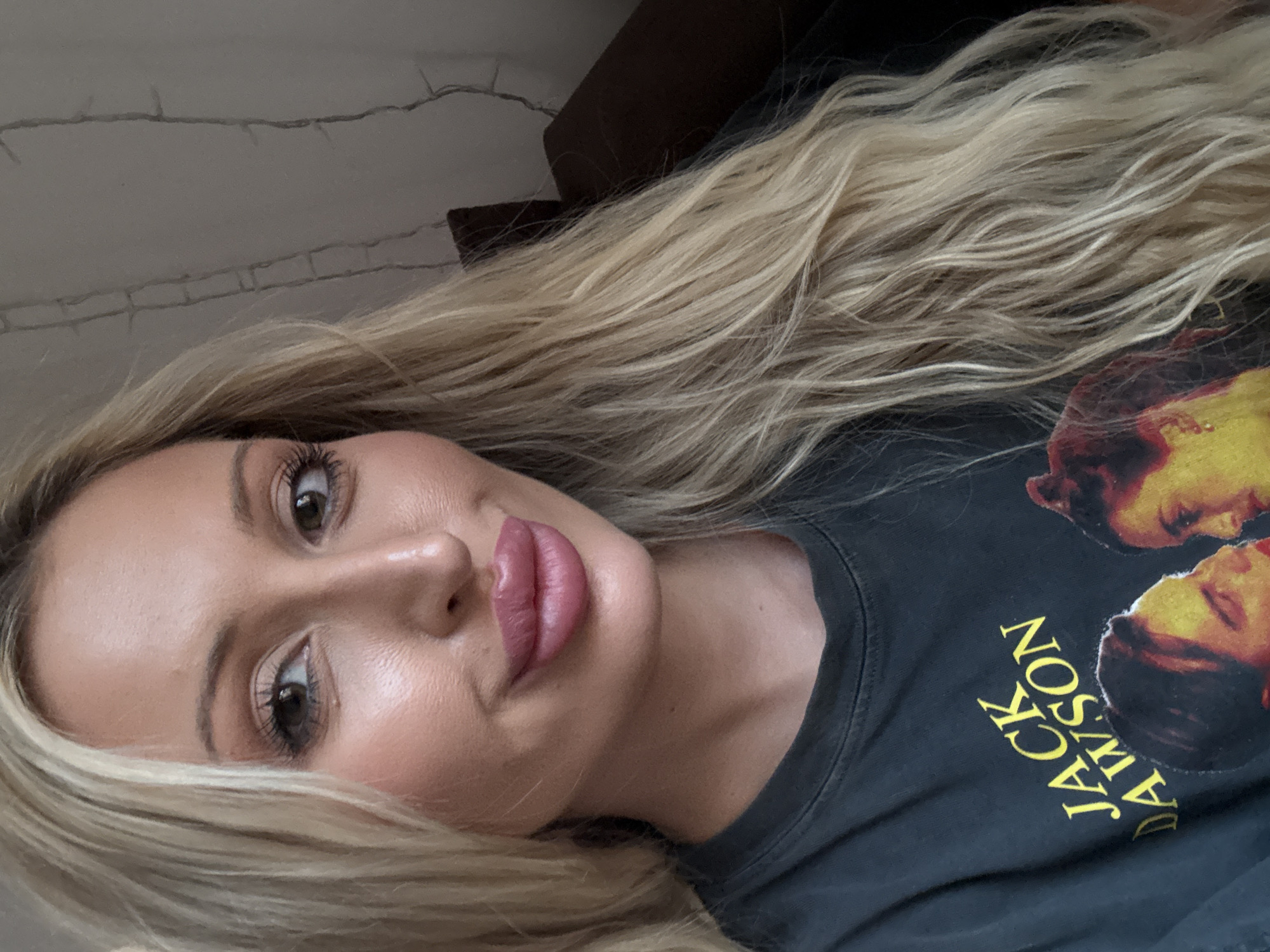 Close-up selfie in dim light, 'Jack Dawson' tee front and center