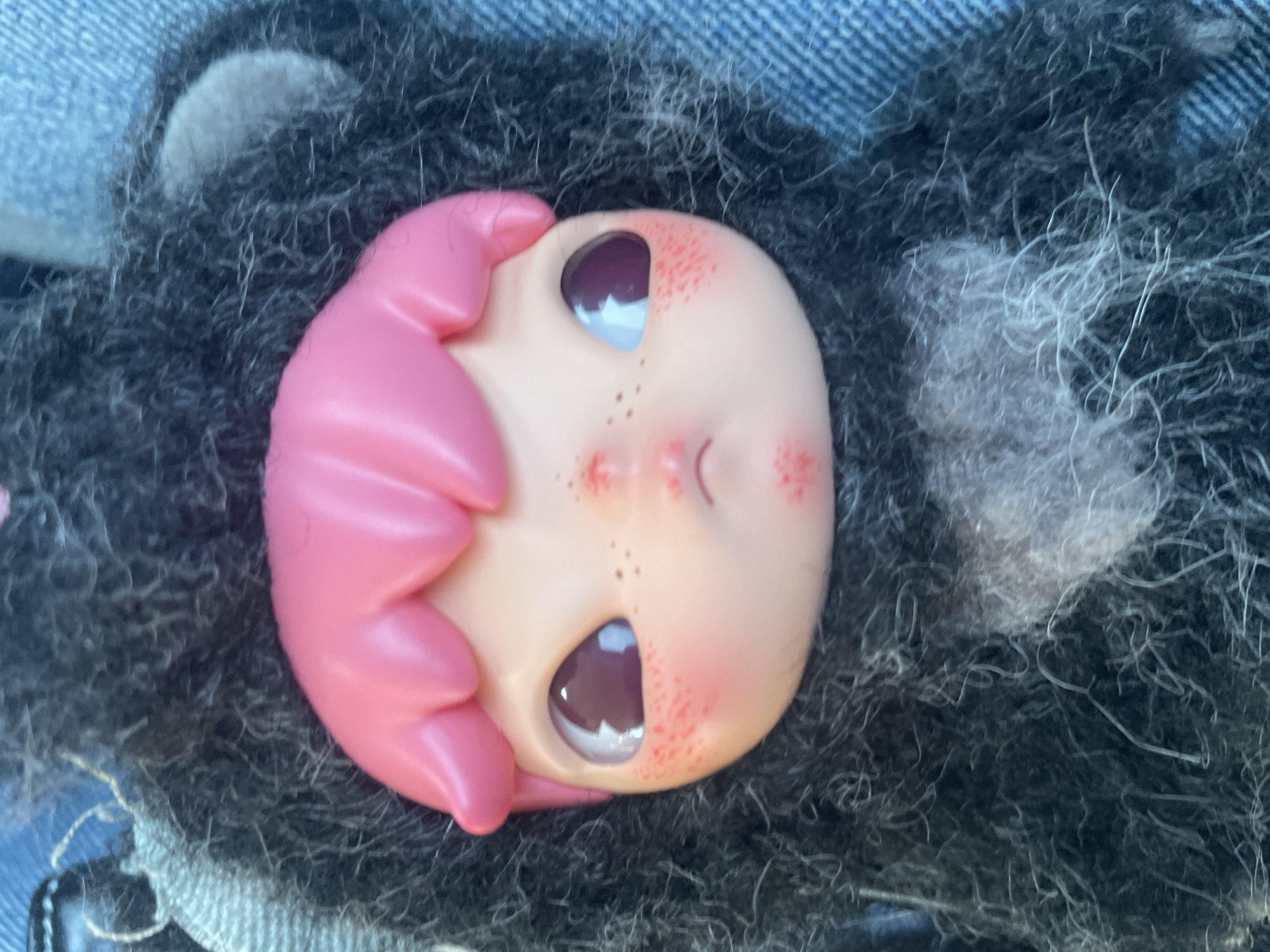 Pink-haired doll spotted in car lap in Denpasar