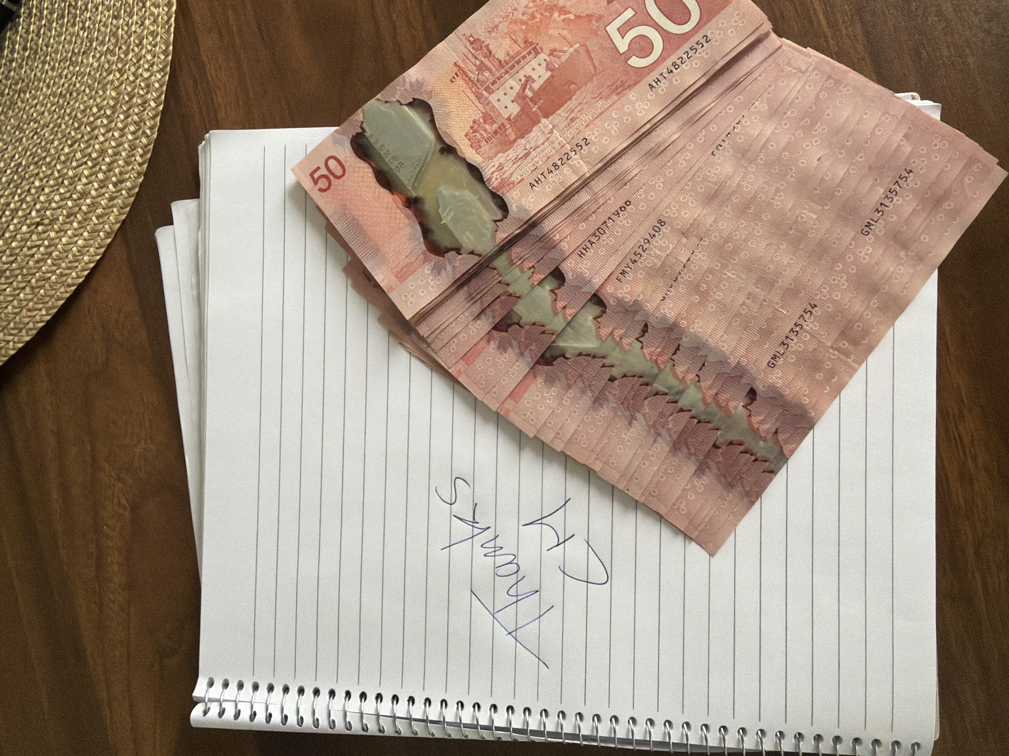 Person handles Canadian cash in Montreal residential setting
