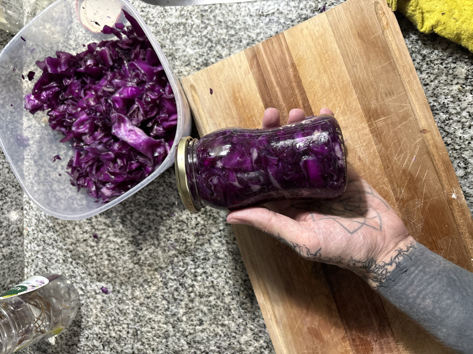 Heavily tattooed person prepares food in Buenos Aires