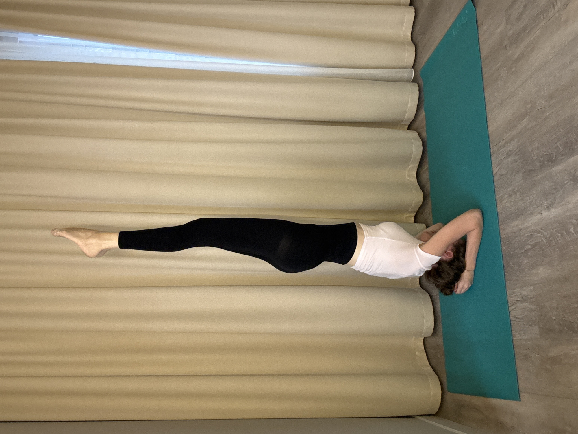 Yoga practice on a teal mat in Dolgoprudny, mid-afternoon