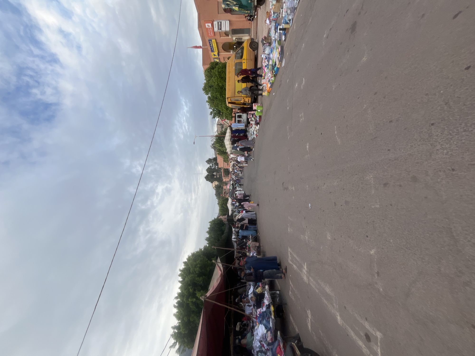 Street market operates in Ouaouizert, Morocco selling pottery and produce