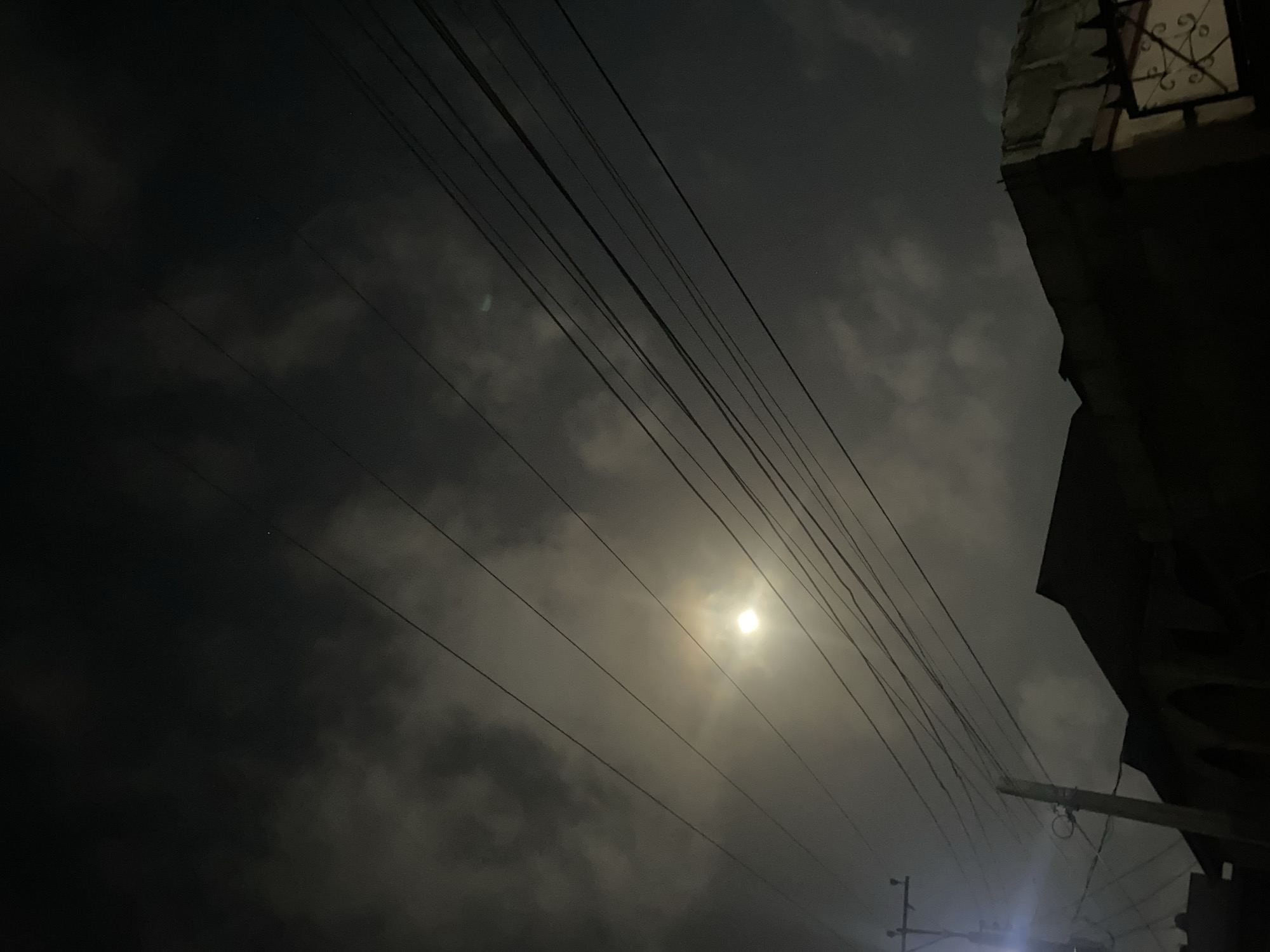 Night scene captured in Lagos showing moonlight through cloudy sky