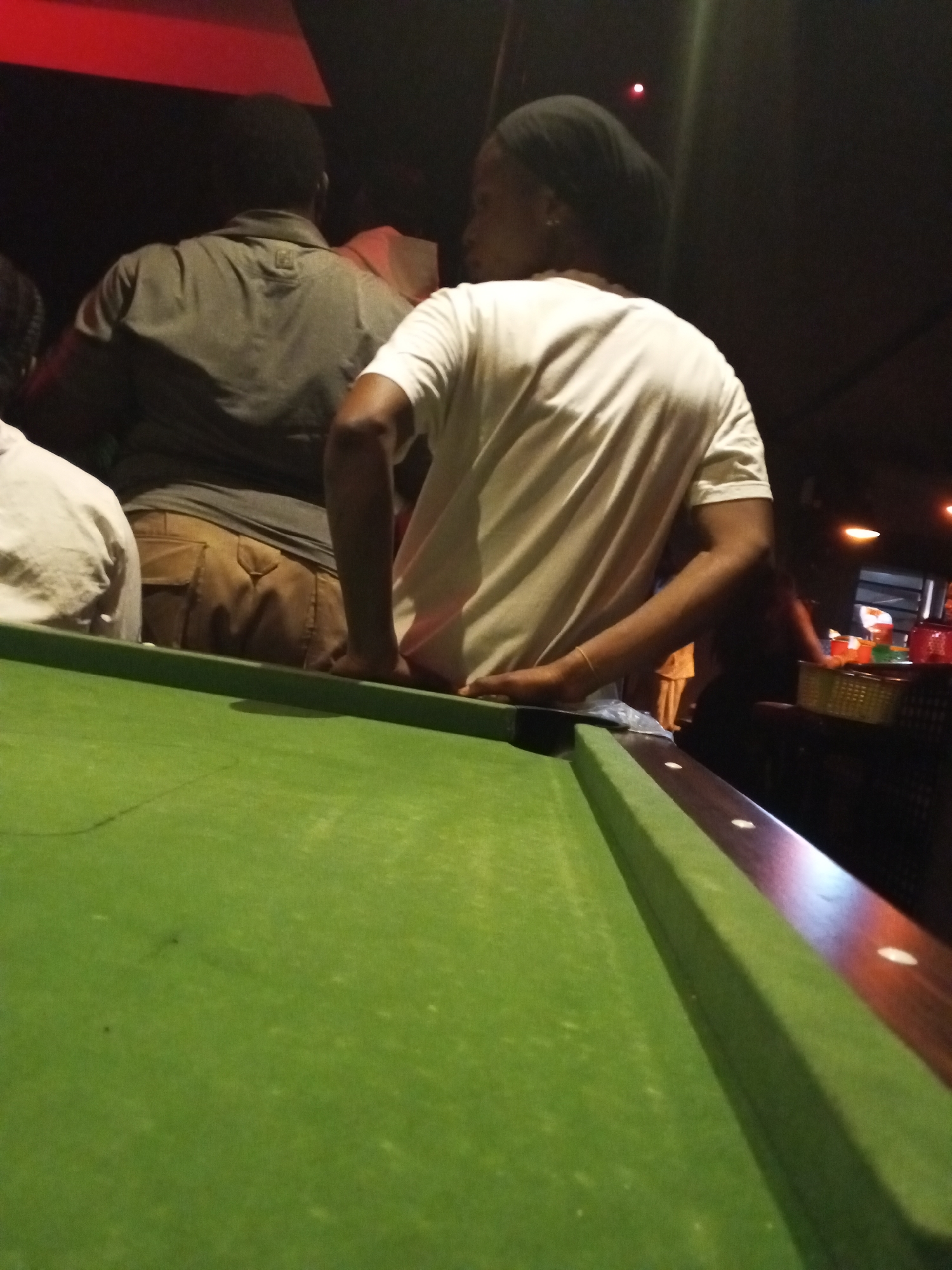 Two people play pool in Lokoja, Nigeria