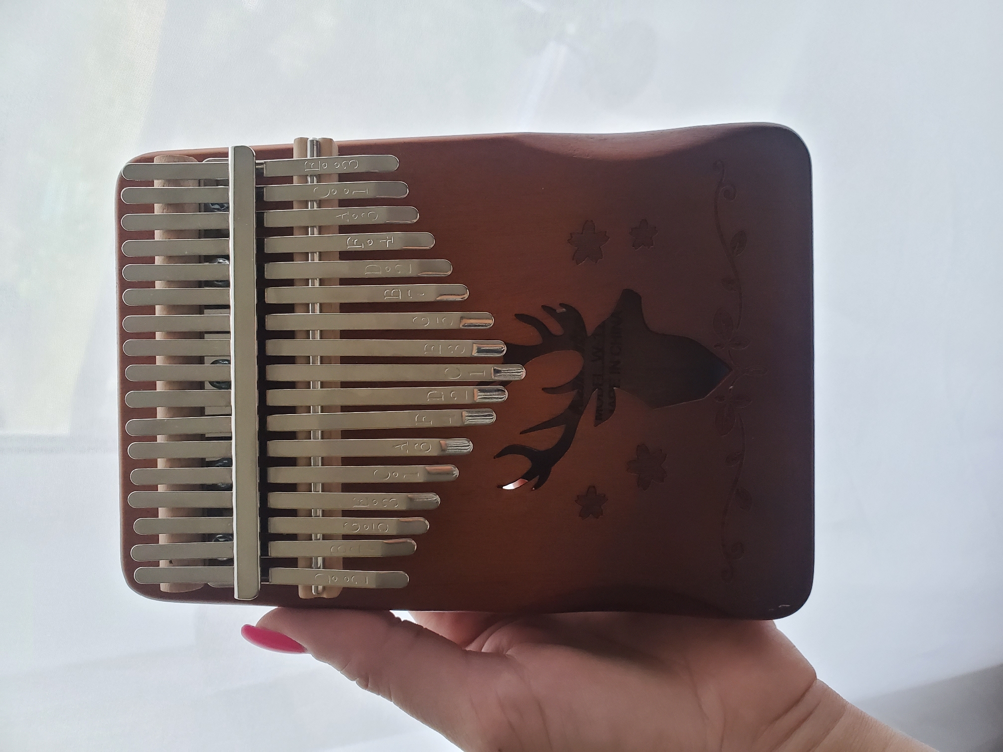 Decorated deer-motif kalimba played in Sayanogorsk