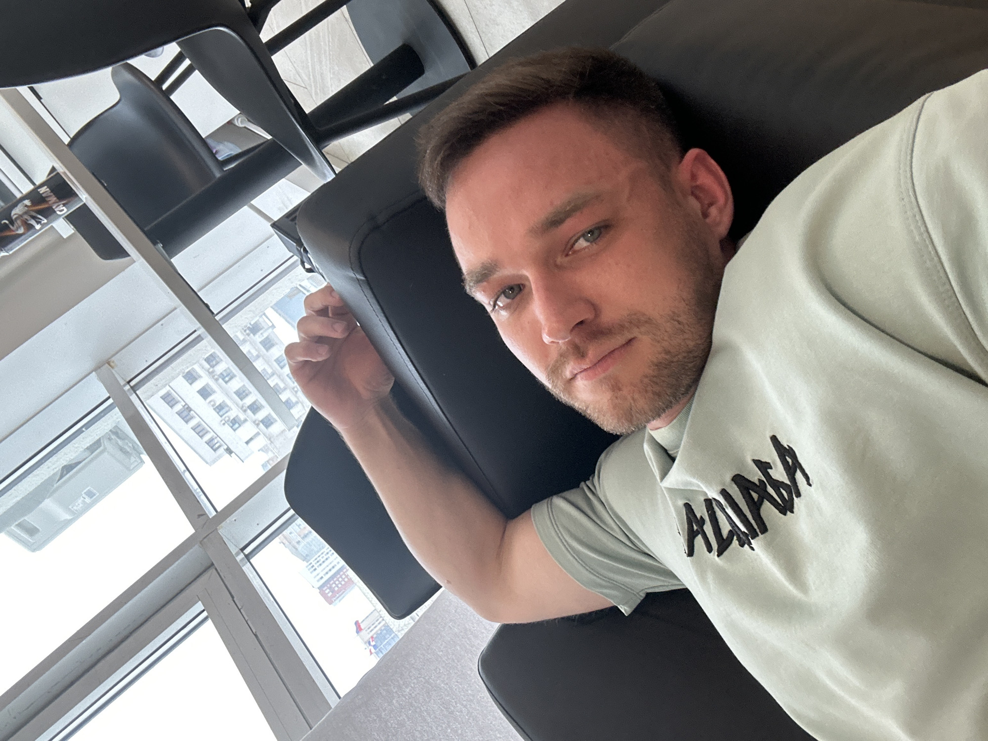 Man photographed in leather chair wearing Balenciaga sweatshirt, Perm