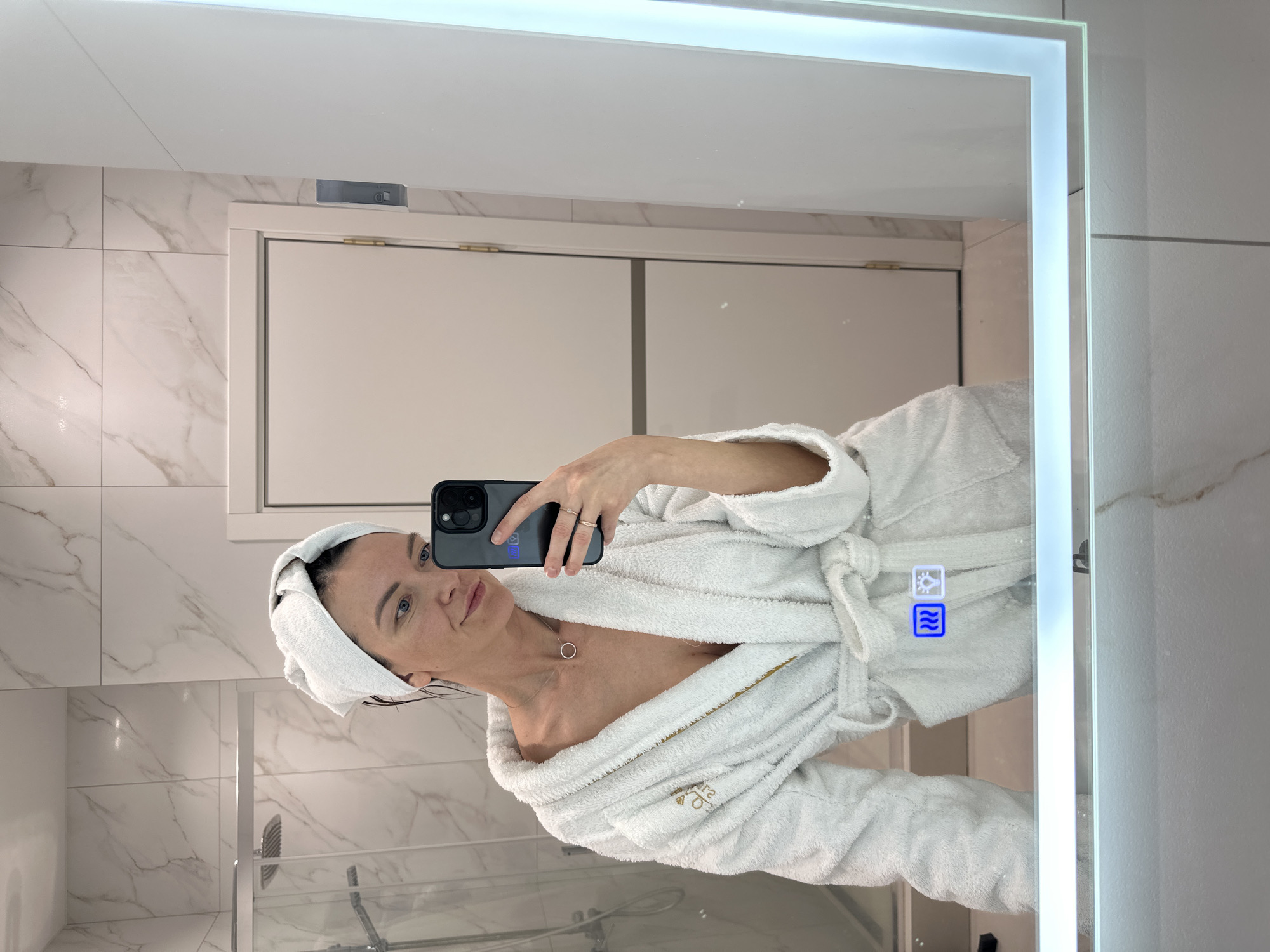Woman takes bathroom mirror selfies in hotel robe, Russia