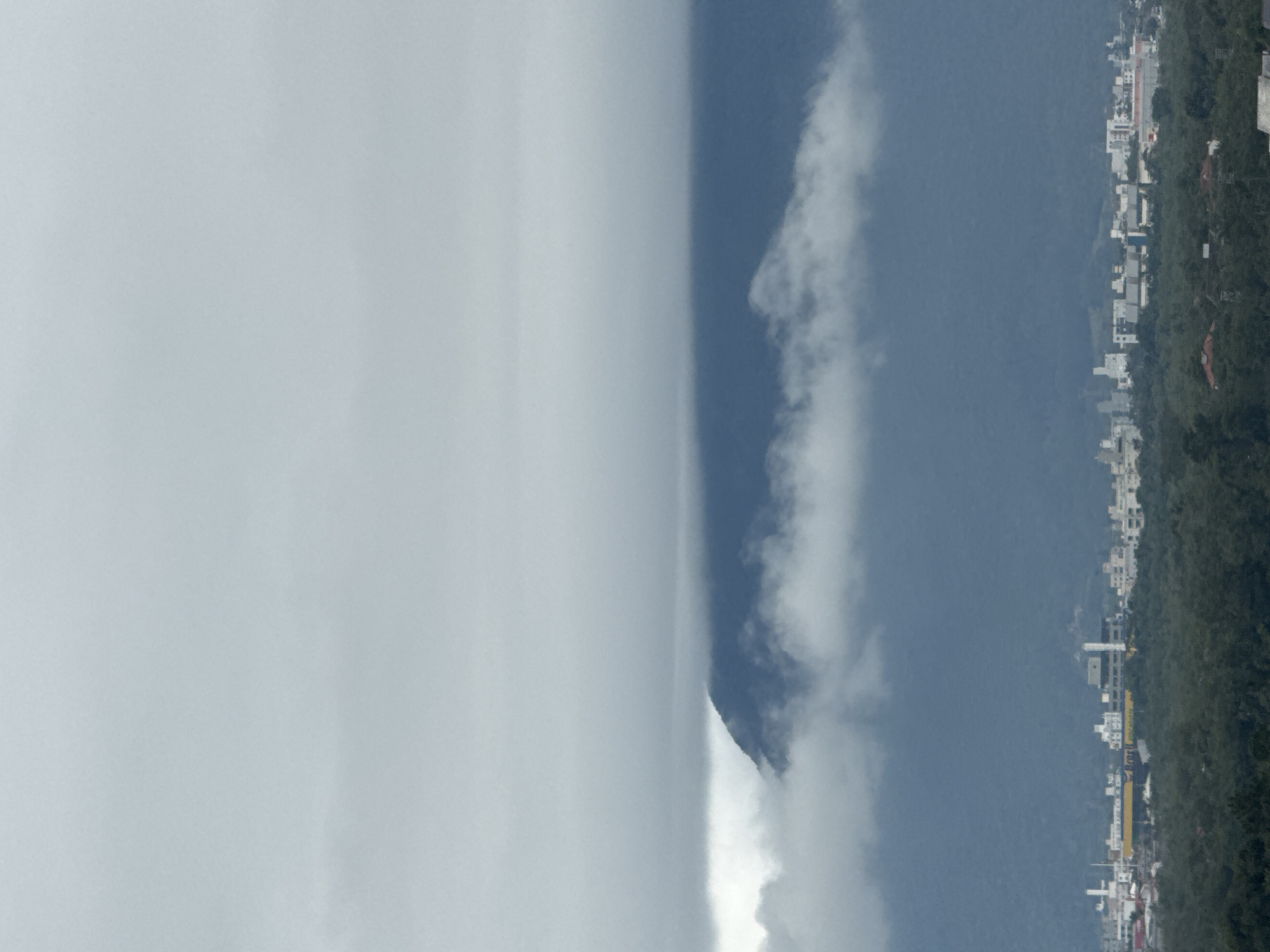 Cloud-covered mountain landscape with a village on the hillside